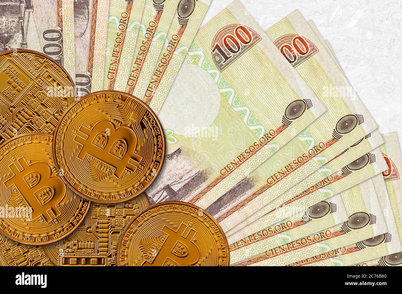100 pesos dominicani e monete d'oro. Concetto di investimento in criptovaluta. Crypto mining o transazioni commerciali Foto Stock