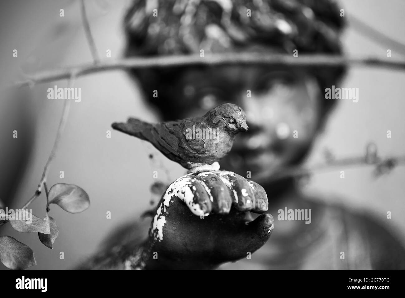 Giardino Cherub statua con un uccello sulla sua mano Foto Stock