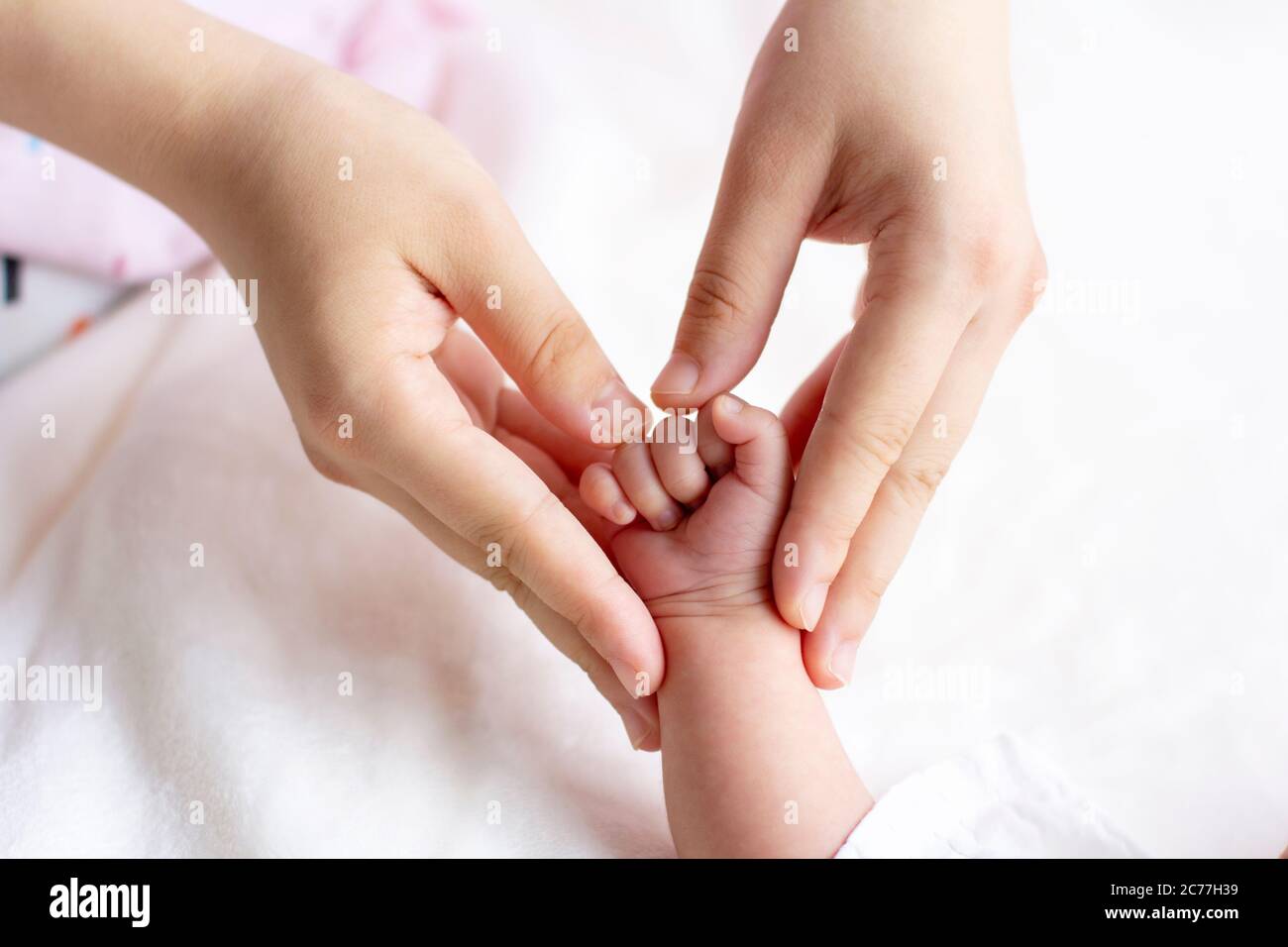 Bambino e madre che tengono le mani e a forma di cuore, tagliato, primo piano Foto Stock