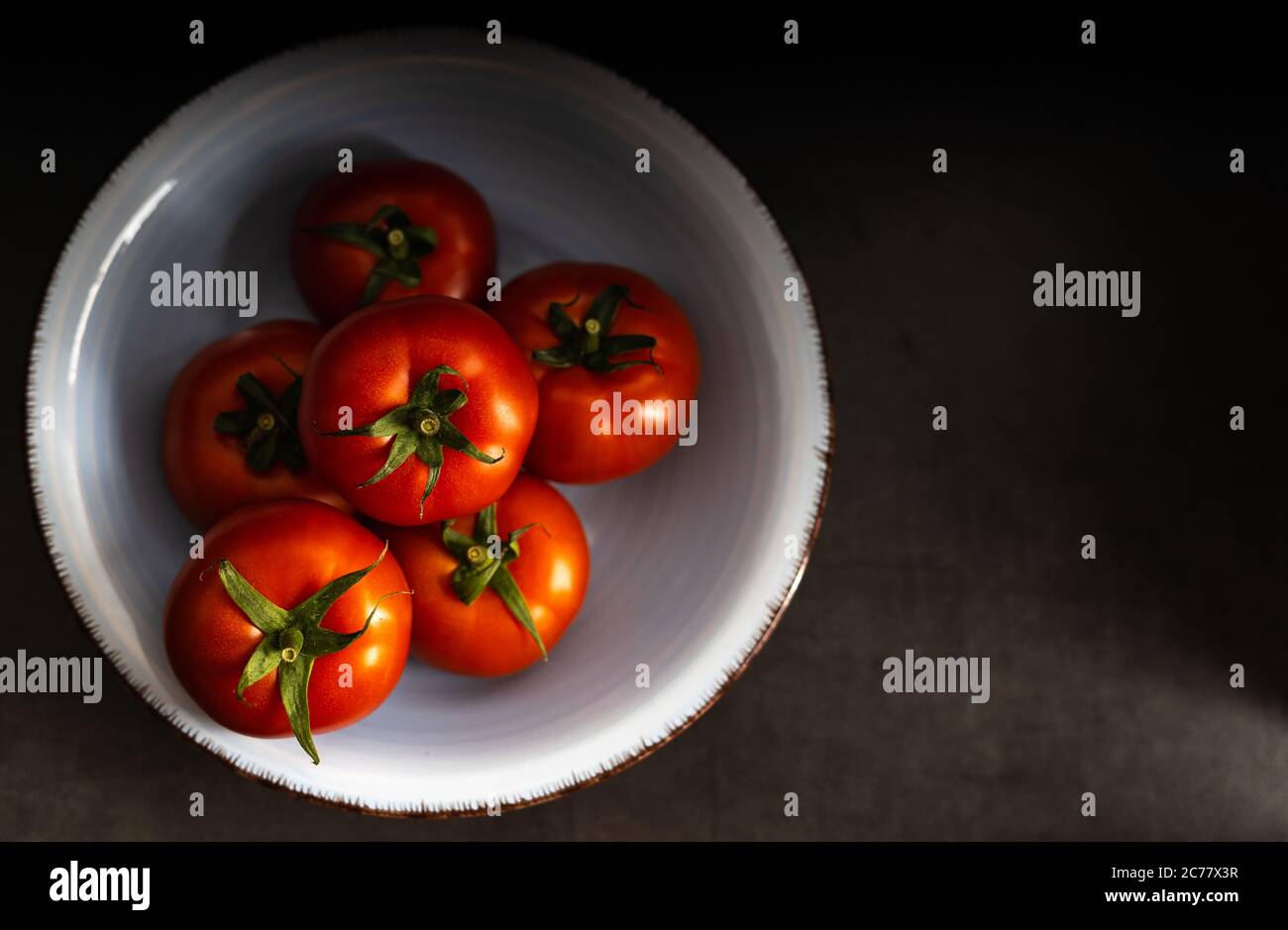 Frutta fresca, delizioso pomodoro su sfondo scuro con spazio per le copie. Vista dall'alto. Foto Stock