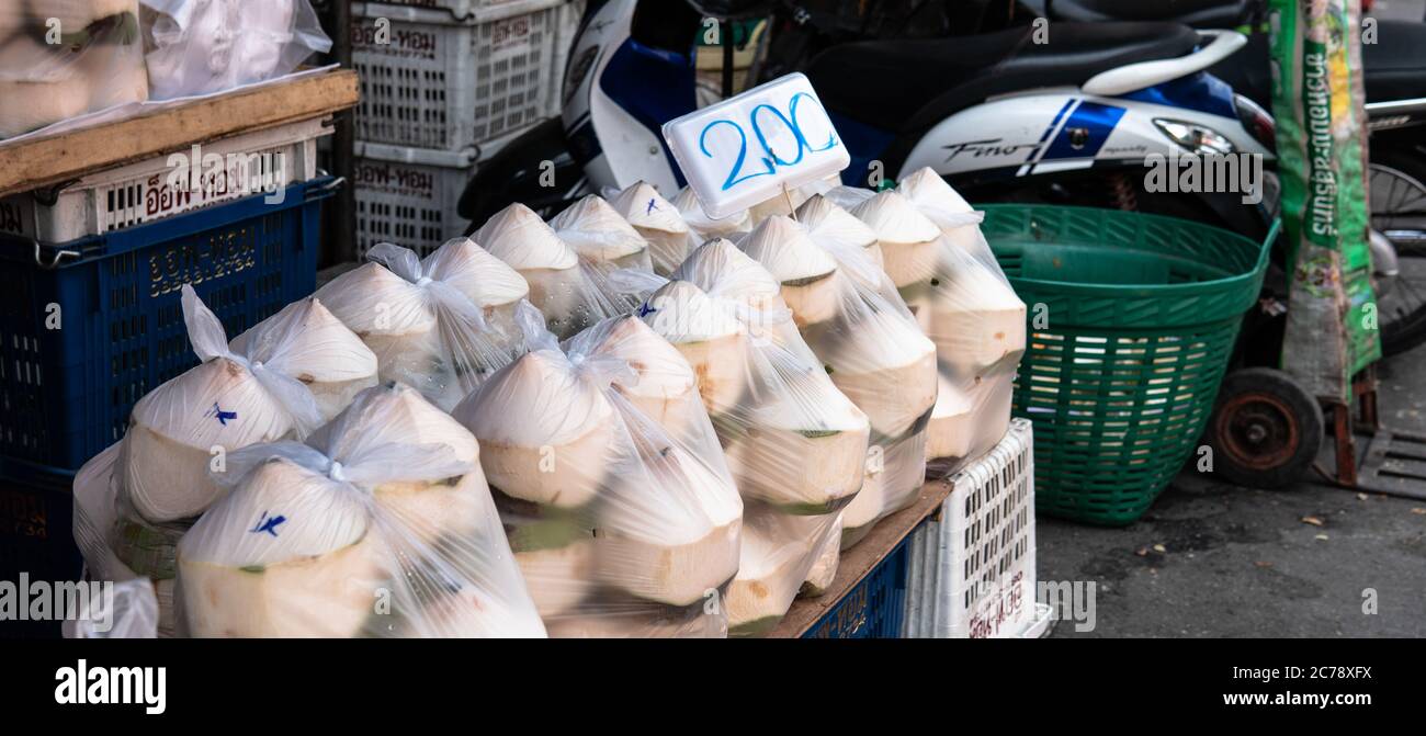 Vendita di noci di cocco nei mercati della frutta in Asia. Benefici di latte di cocco e polpa Foto Stock