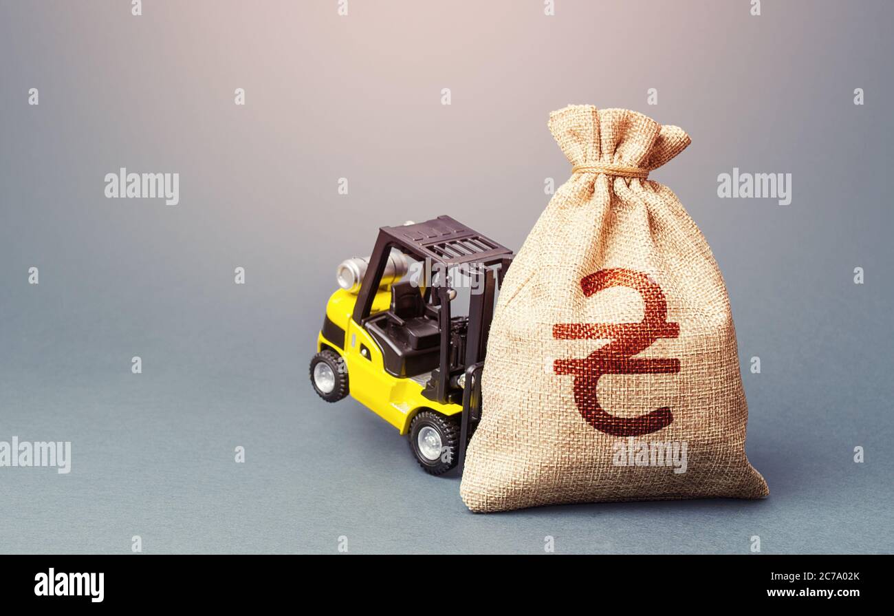 Un carrello giallo non può sollevare un sacchetto di denaro ucraino hryvnia. Tasso di interesse. Stimolare l'economia. Denaro per elicotteri, sussidi prestiti agevolati. Pinna più forte Foto Stock