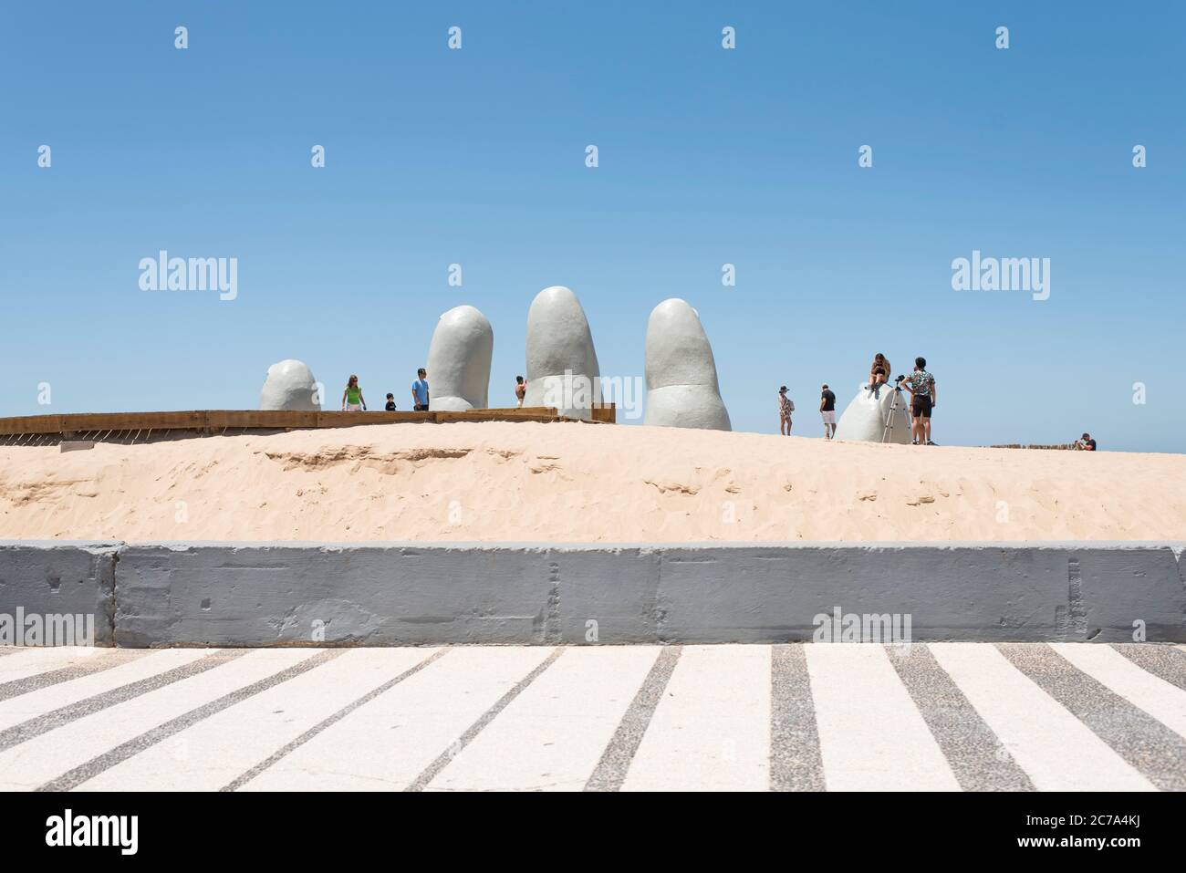 Punta del Este, Maldonado / Uruguay; 1 gennaio 2019: La mano, le dita o l'uomo che si è fatto emergere nella vita, una scultura popolare di cinque dita che emerge dal s. Foto Stock