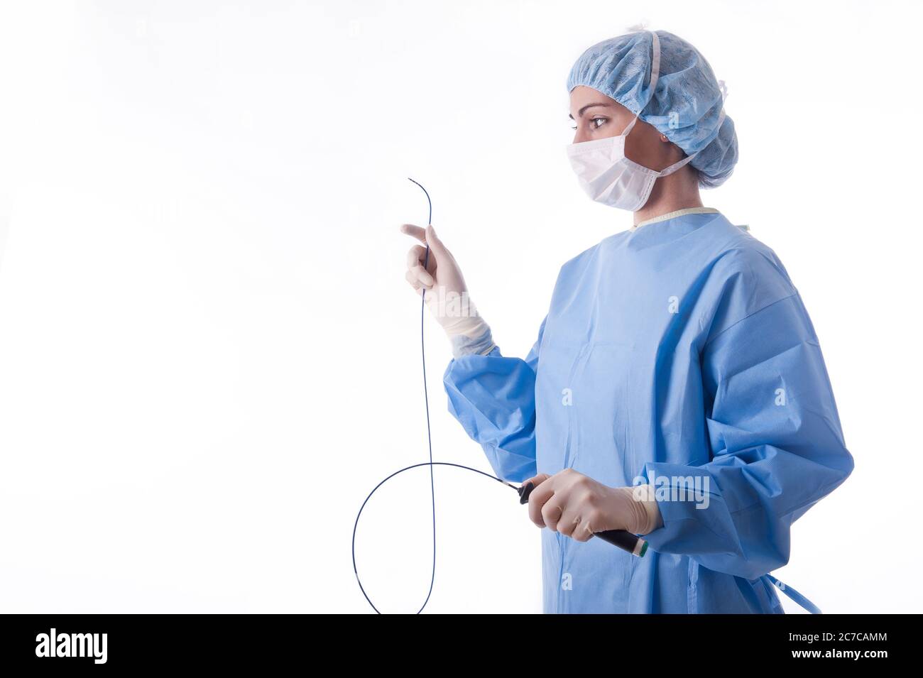 Medico o infermiere di sesso femminile che indossa una tuta o un abito  sterile blu che tiene un catetere per l'ablazione per una procedura  cardiaca Foto stock - Alamy