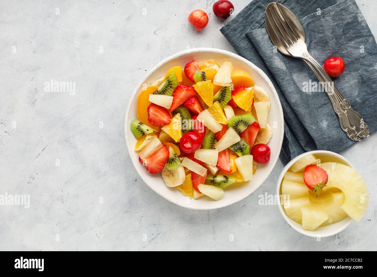 Insalata di frutta fresca tritata in un recipiente. Vista dall'alto. Foto Stock