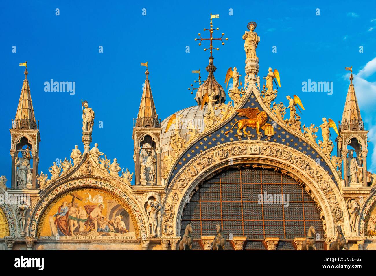 Basilica San Marco riflessa in acqua alta in Piazza San Marco al crepuscolo durante il tramonto, Venezia, Italia con sfocatura motiva sulla folla dei turisti Foto Stock