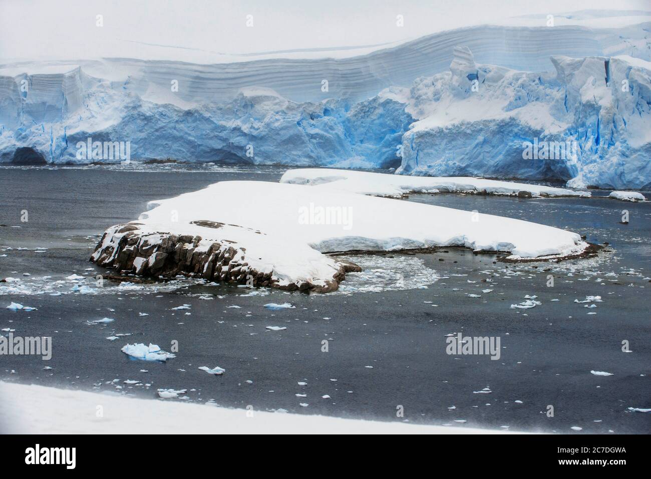 Big iceberg e cielo moody Portal Point Antartico Penisola Antartica Antartide. Il RCGS Resolute One Ocean Navigator, un cinque stelle polare ghiaccio-rinforzato espulso Foto Stock