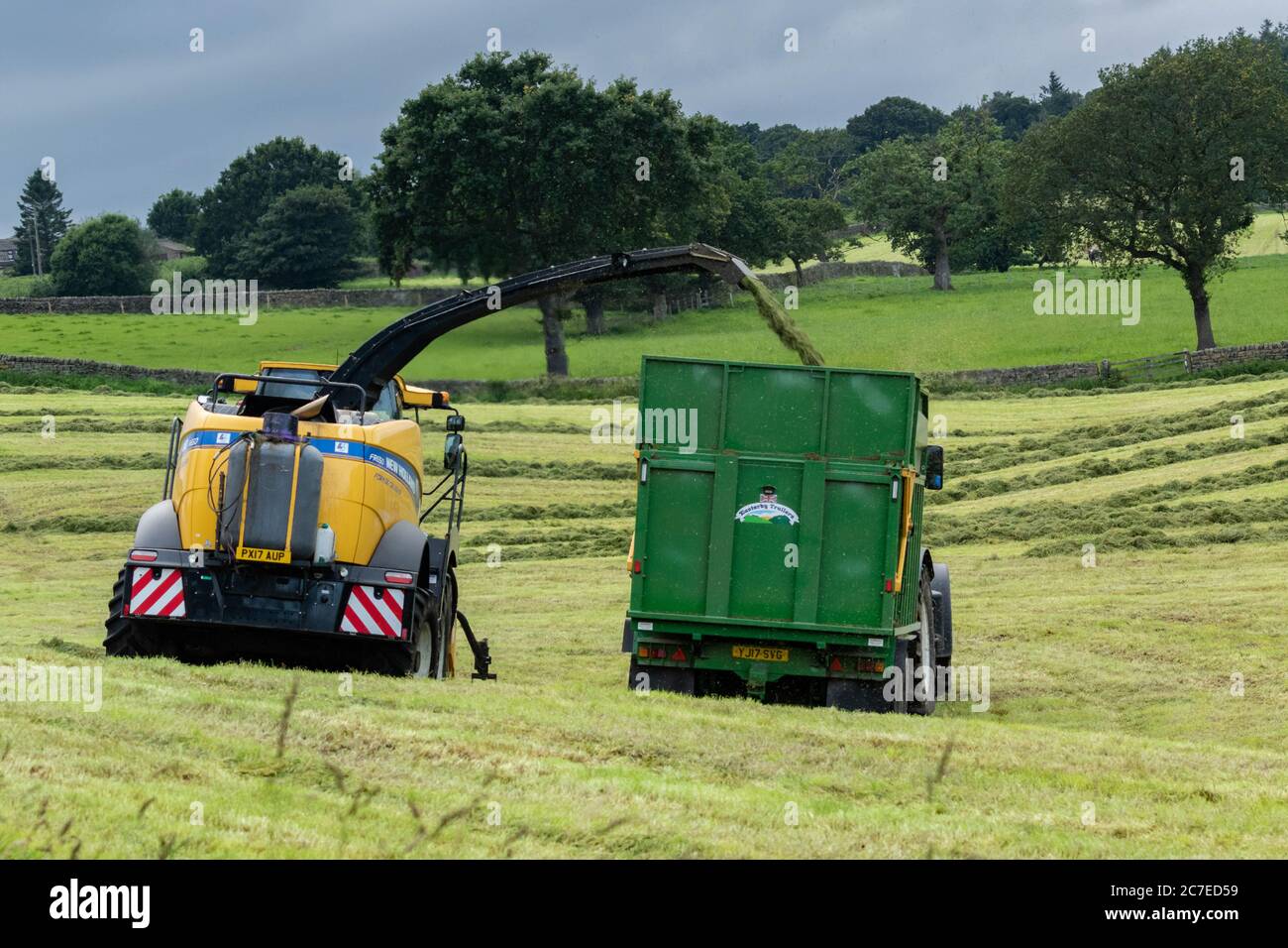 Veicoli agricoli che raccolgono insilato in una fattoria dello Yorkshire in Inghilterra, Regno Unito Foto Stock