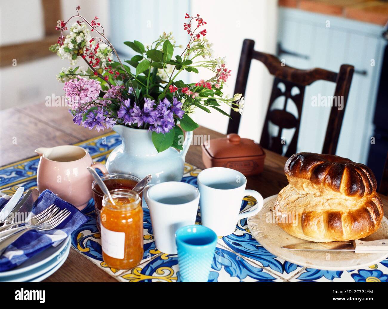 Primo piano di una cucina di campagna tavolo da pranzo posato per la colazione in un cottage tradizionale con tetto di paglia in Norfolk Foto Stock