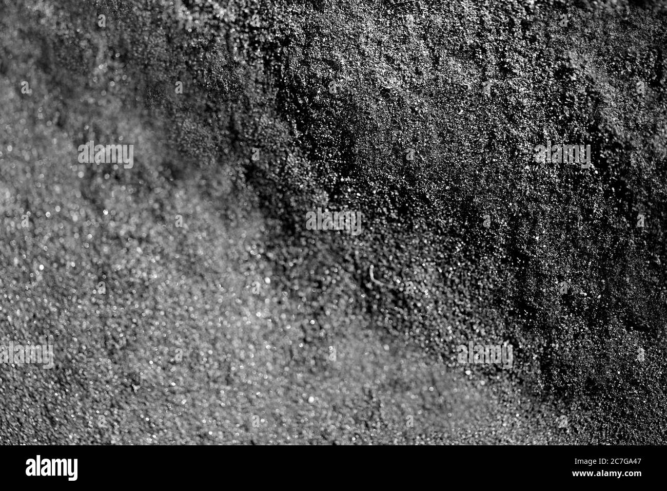 Sfondo fotografico di sabbia nera sulla riva Foto Stock