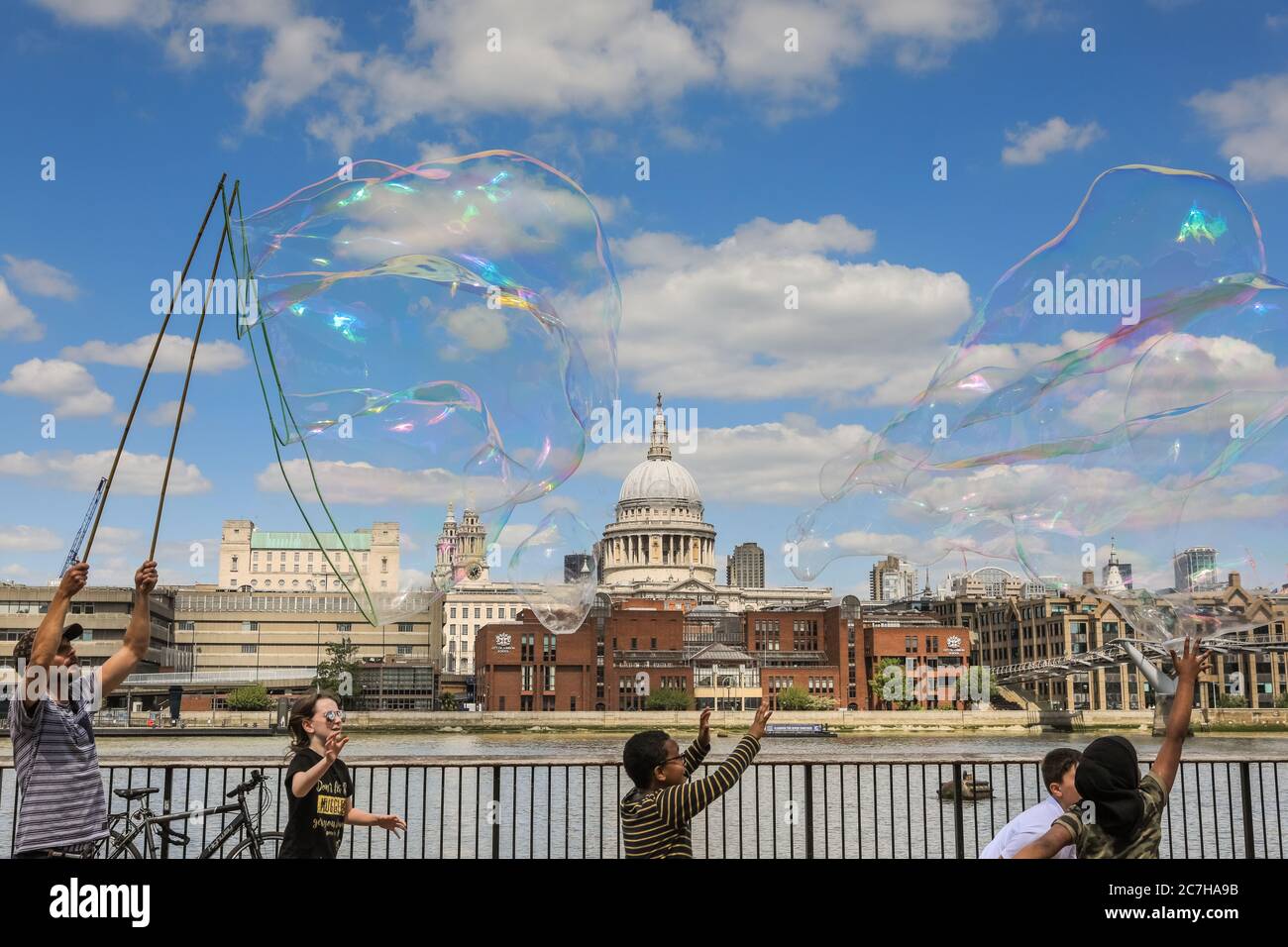 Londra, Regno Unito. 17 luglio 2020. Un'artista che fa la bolla del sapone intrattiene i bambini e gli adulti davanti ad uno splendido sfondo della Cattedrale di St Paul. Il sole e le temperature calde sono fissati per continuare nel fine settimana. Credit: Imageplotter/Alamy Live News Foto Stock