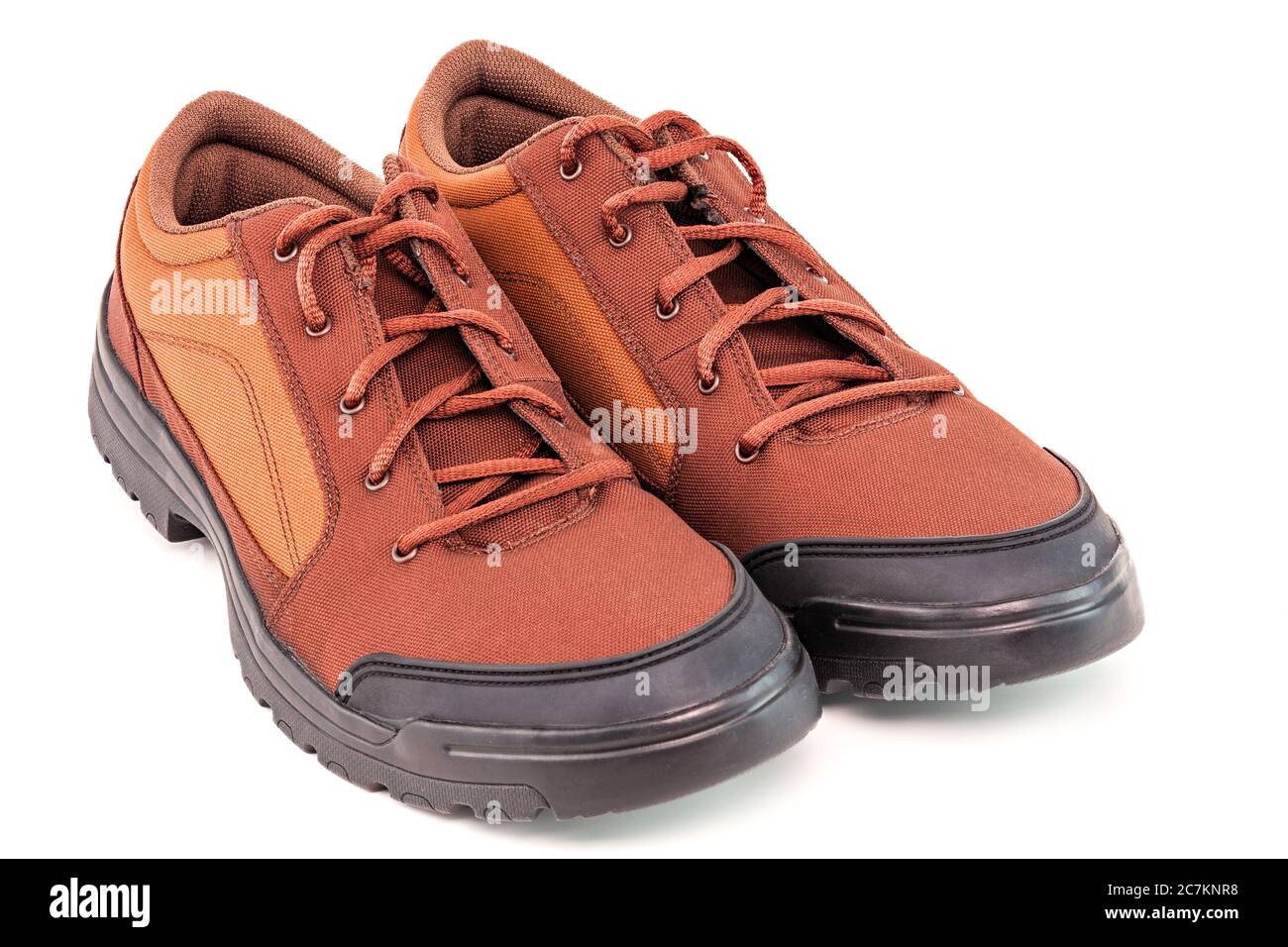 un paio di scarpe da viaggio arancioni in tessuto durevole e a buon mercato isolato su sfondo bianco Foto Stock