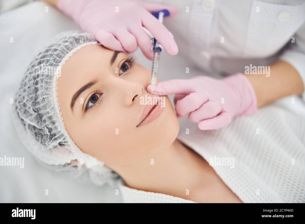 La paziente piuttosto femminile sta ricevendo la terapia iniettabile Foto Stock