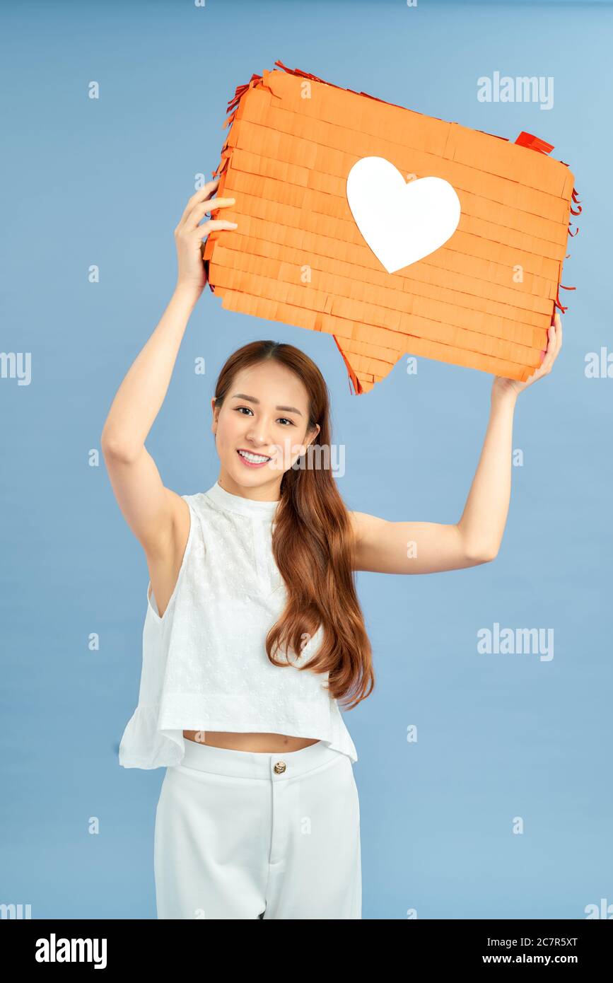 Donna che tiene la bolla del discorso con l'icona del cuore Foto Stock