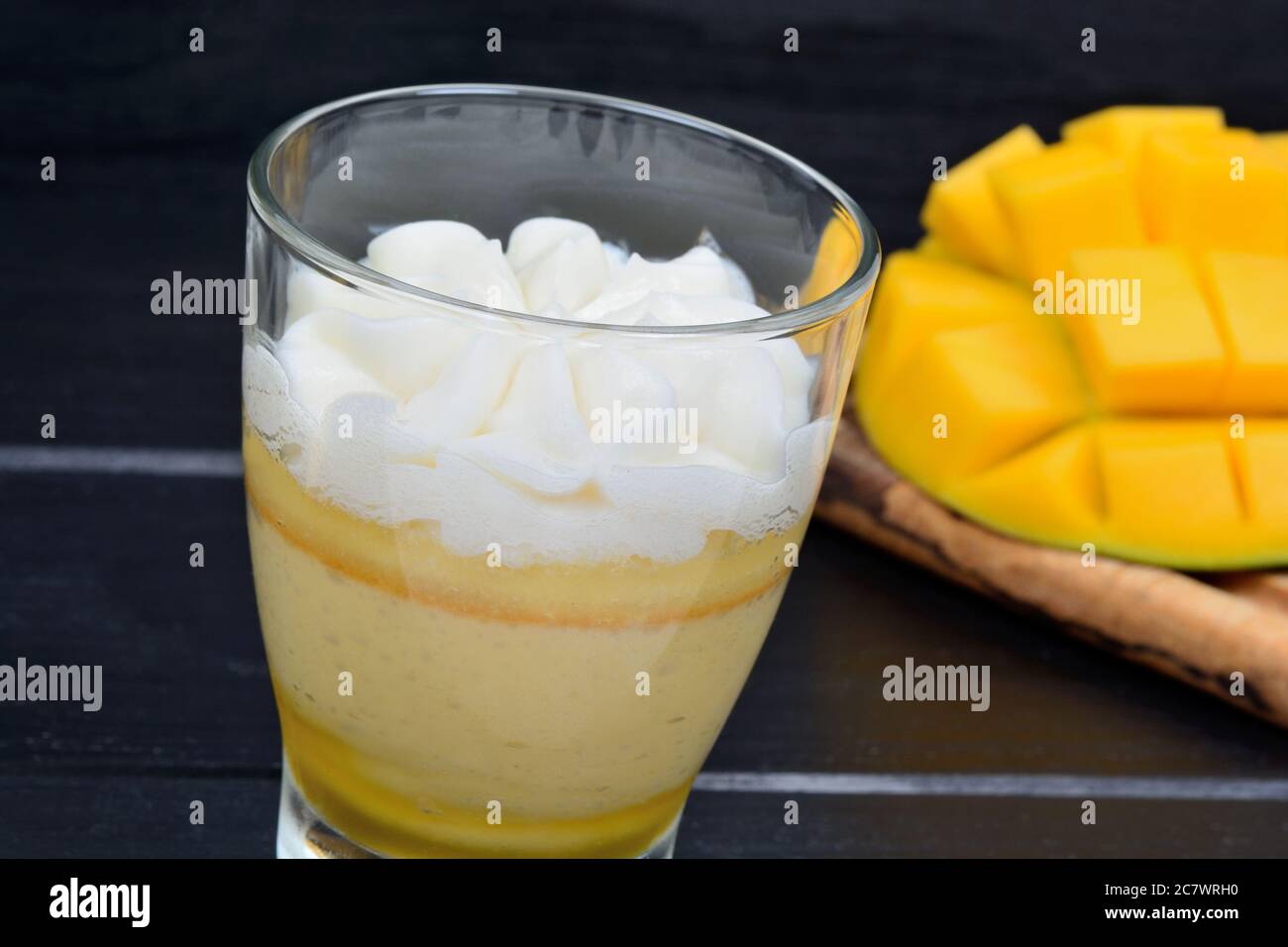 Budino di frutta di mango in un bicchiere sul tavolo Foto Stock