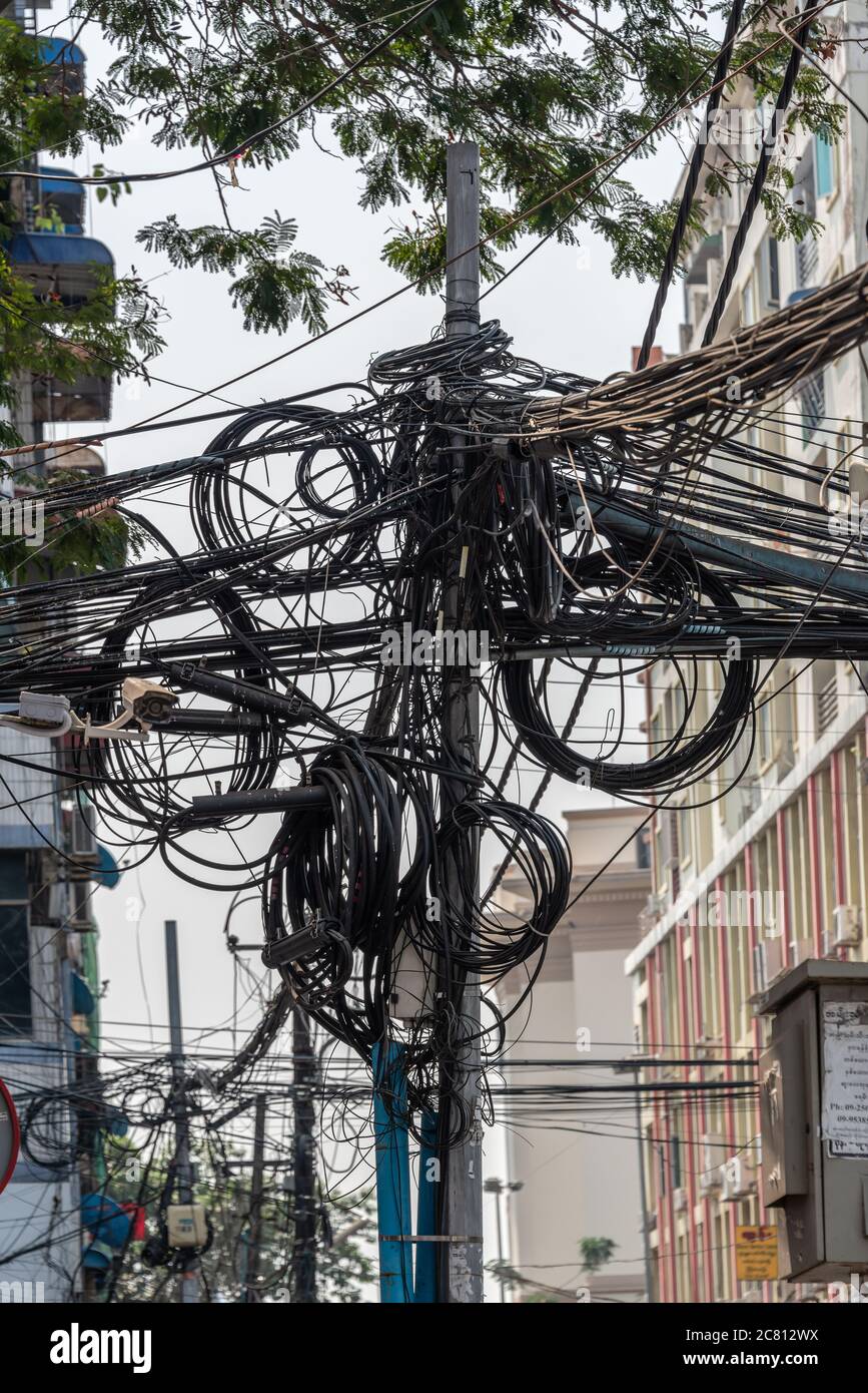 Cavi elettrici aggrovigliati in una strada di Yangon, Birmania, Myanmar Foto Stock