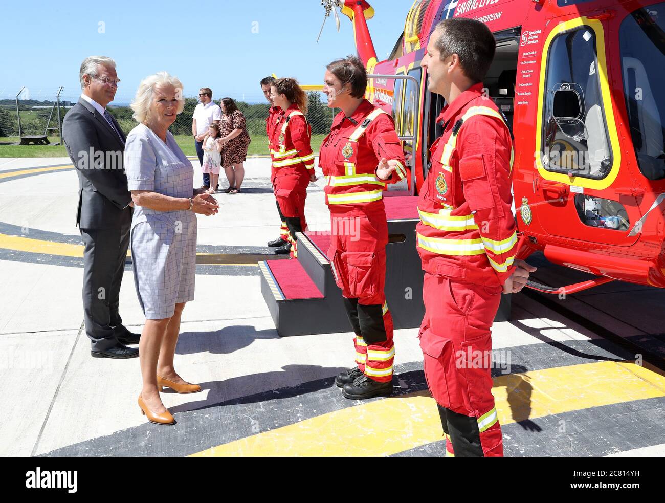 La Duchessa di Cornovaglia parla con l'equipaggio durante una visita alla base del Cornovaglia Air Ambulance Trust a Newquay per lanciare il nuovo elicottero 'Duchessa di Cornovaglia', mentre in una visita di tre giorni a Cornovaglia con il Principe di Galles. Foto Stock
