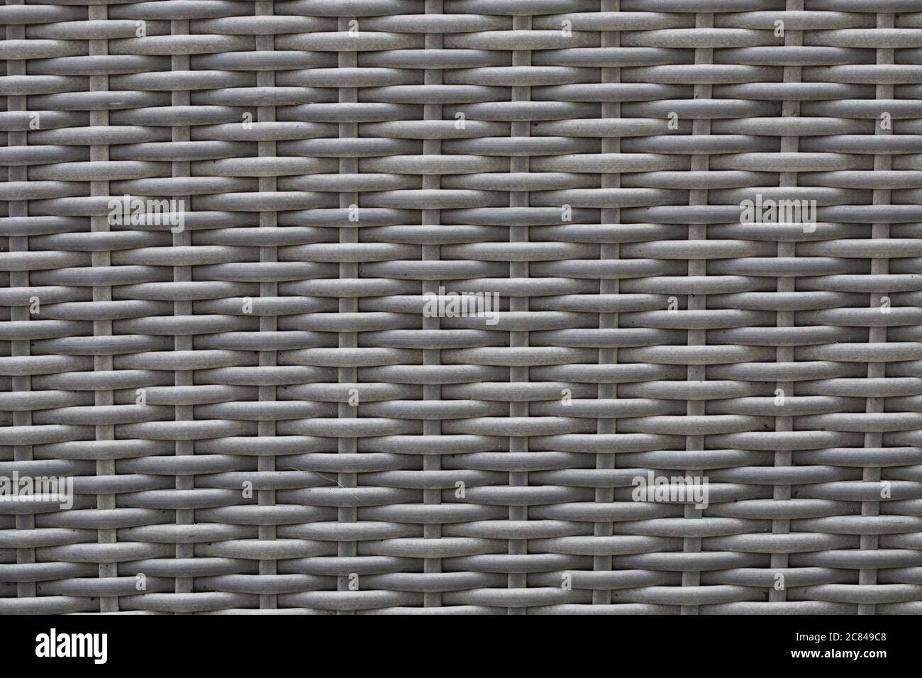 Uno sfondo a cornice pieno di rattan grigio con spazio di copia Foto Stock
