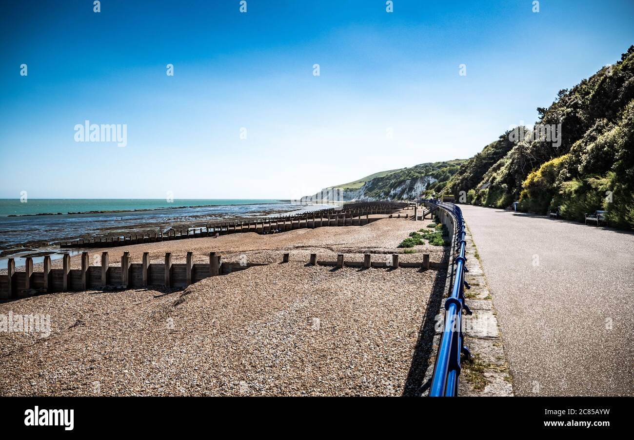 Eastbourne Promenade, East Sussex, Inghilterra. Una vista lungo il fronte mare verso le bianche scogliere delle Downs Sud che si affacciano sul canale Inglese. Foto Stock