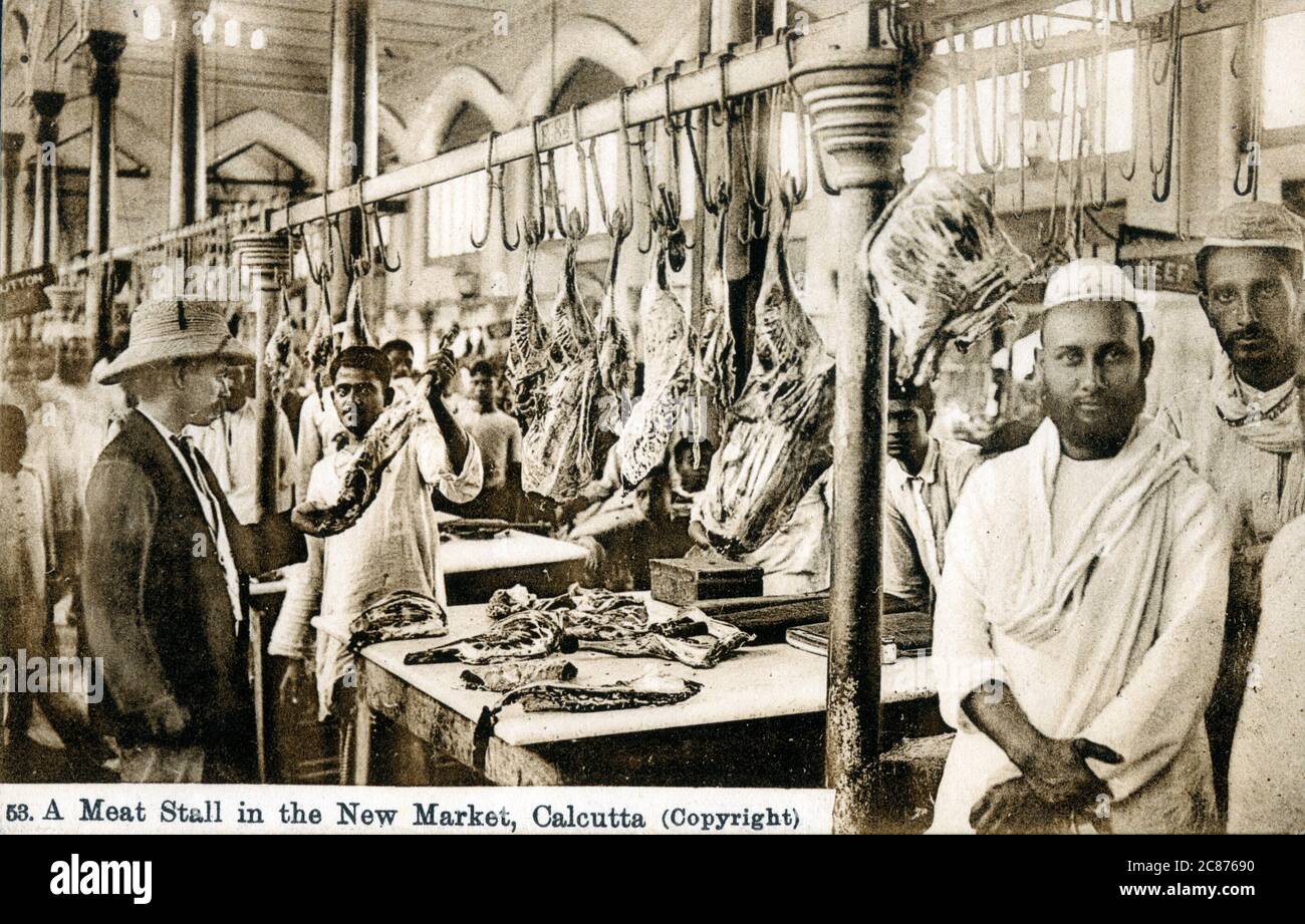 (Capra) Meat Stall - New Market, Calcutta (Calcutta), stato del Bengala Occidentale, India. I due gentiluomini a destra sono chiaramente musulmani e quindi praticano la macelleria Halal. Foto Stock