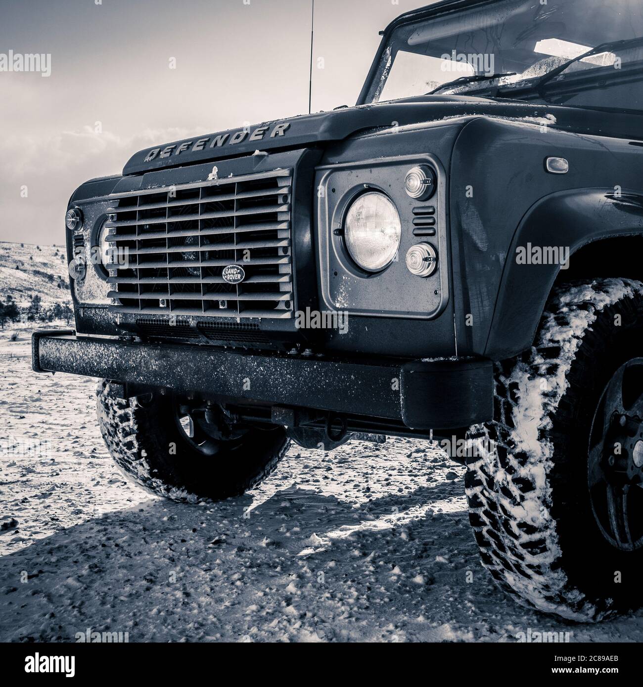 Parte anteriore della Land Rover Defender a trazione integrale con terreno coperto da neve. Foto Stock