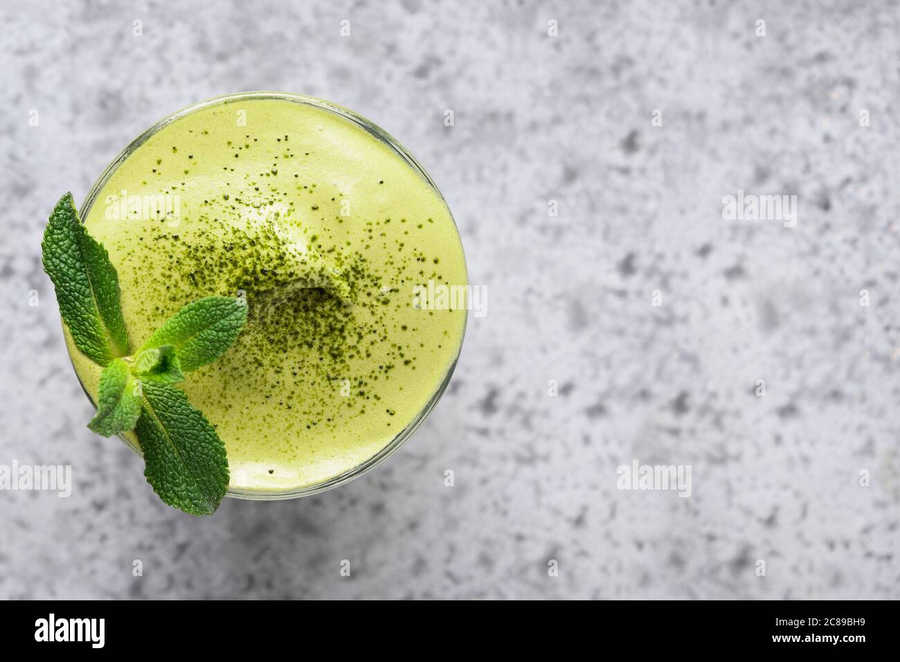 Tè Dalgona Iced Matcha guarnire la menta sul grigio. Primo piano. Foto Stock