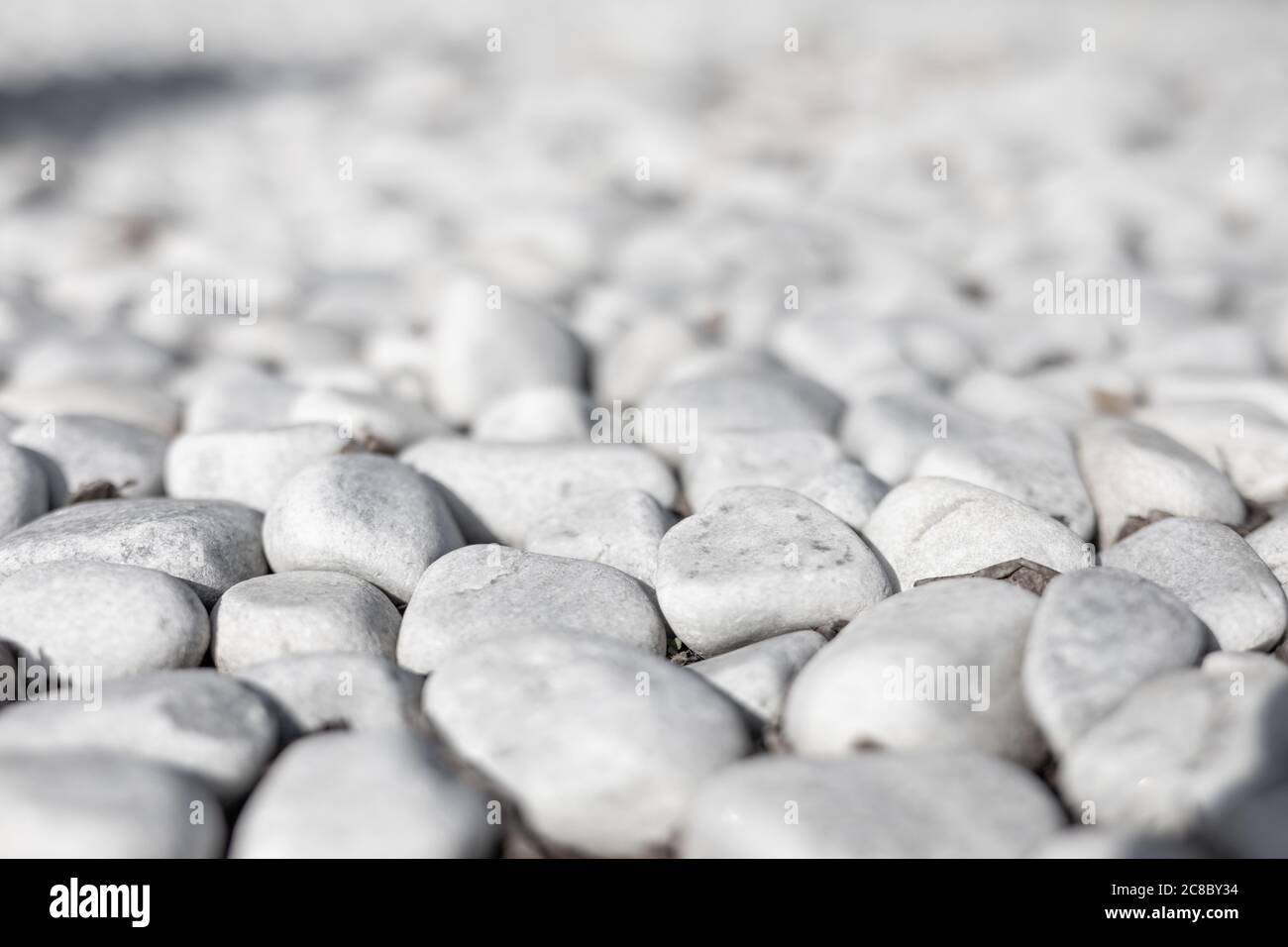 Sfondo bianco in pietra. Pietra bianca di ciottoli per sfondo. Foto Stock