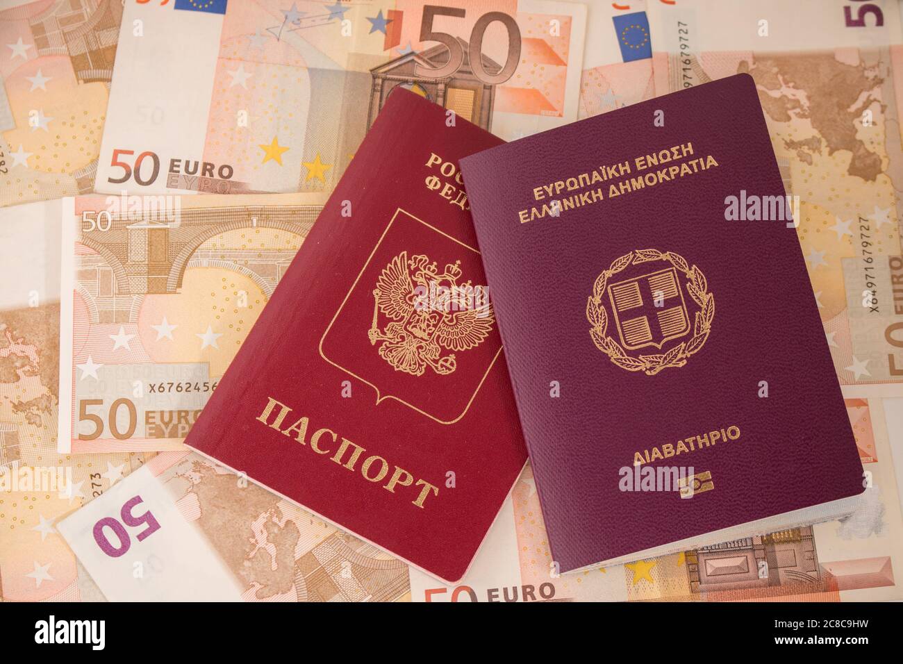 Passaporti sulla banconota sfondo. Il russo e il Greco di passaporti. Le banconote in euro 50 cinquanta. Il viaggio e il denaro. Foto Stock