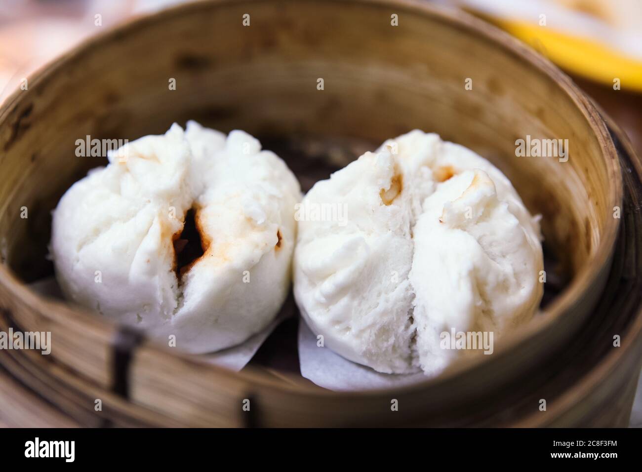 Delizioso Char Siew Bao al vapore servito in un cestino di bambù Foto Stock