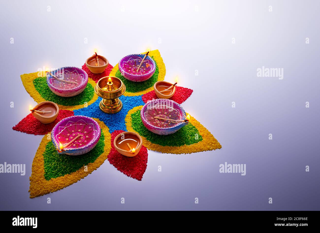 Happy Diwali, lampade diya illuminate su rangoli colorati con spazio per la copia Foto Stock