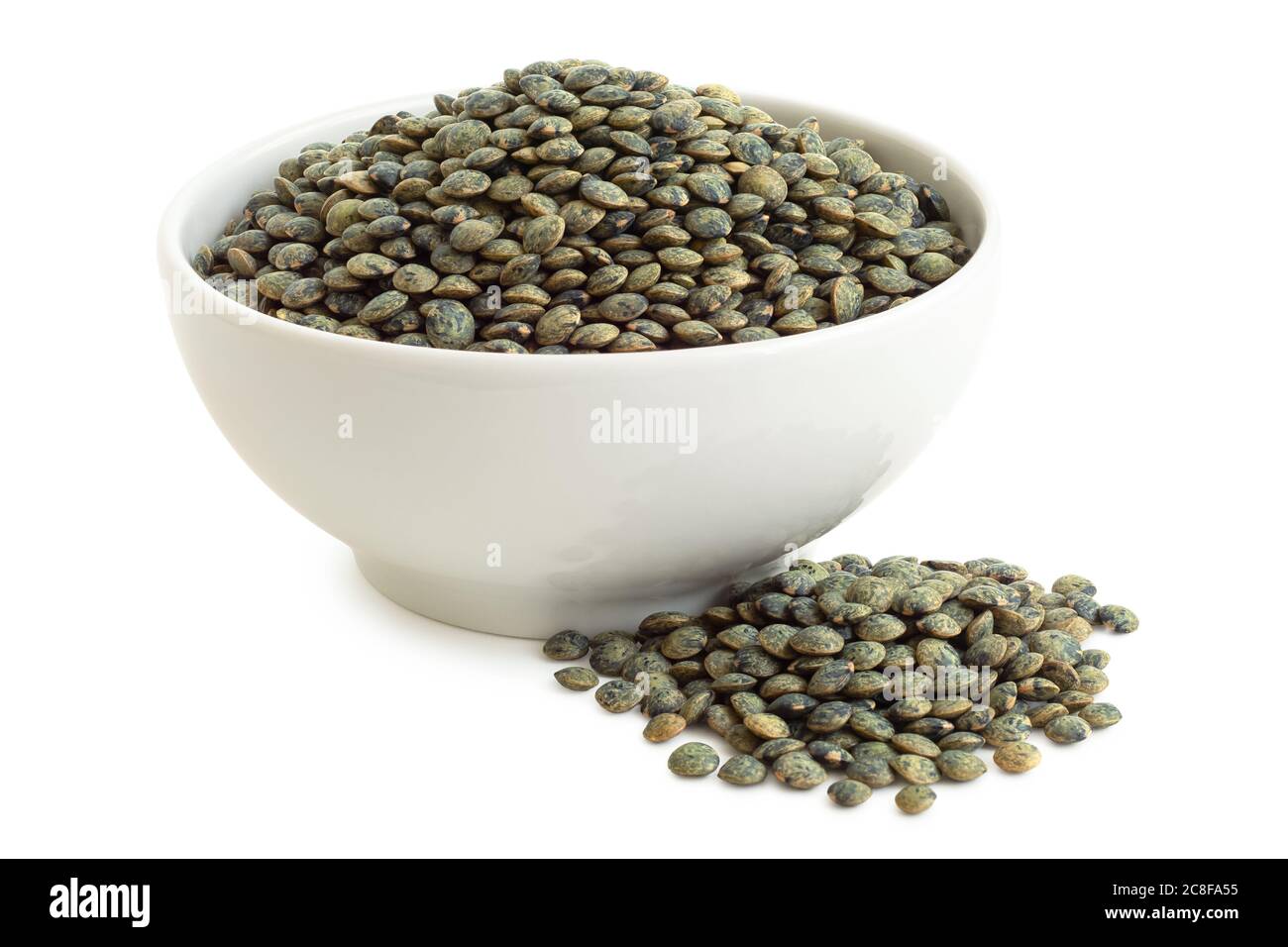 Le lenticchie verdi francesi secche di puy in ceramica bianca accanto al mucchio di lenticchie isolate su bianco. Angolo alto. Foto Stock