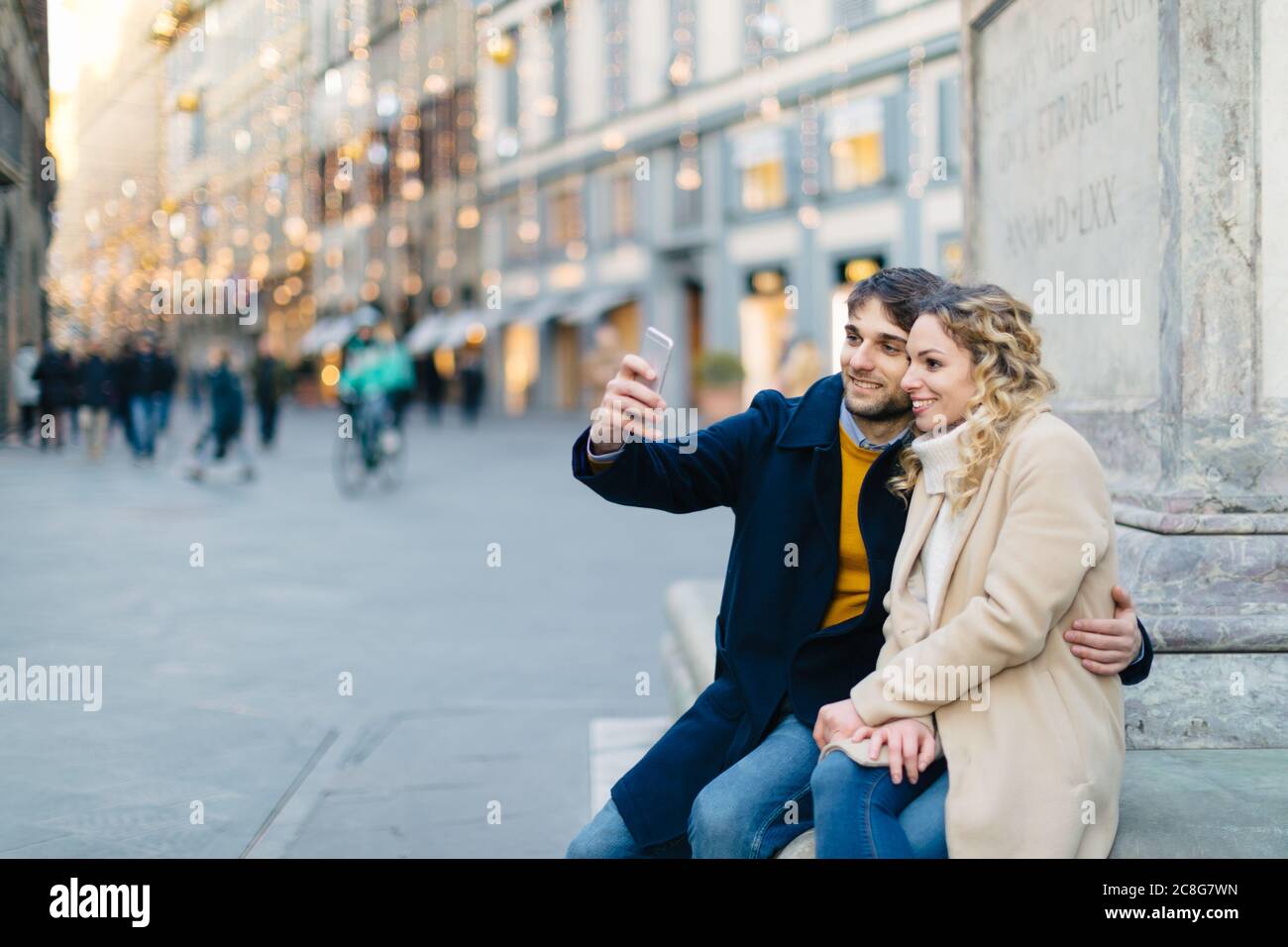 Giovane tenendo selfie a piazza Firenze, Toscana, Italia Foto Stock