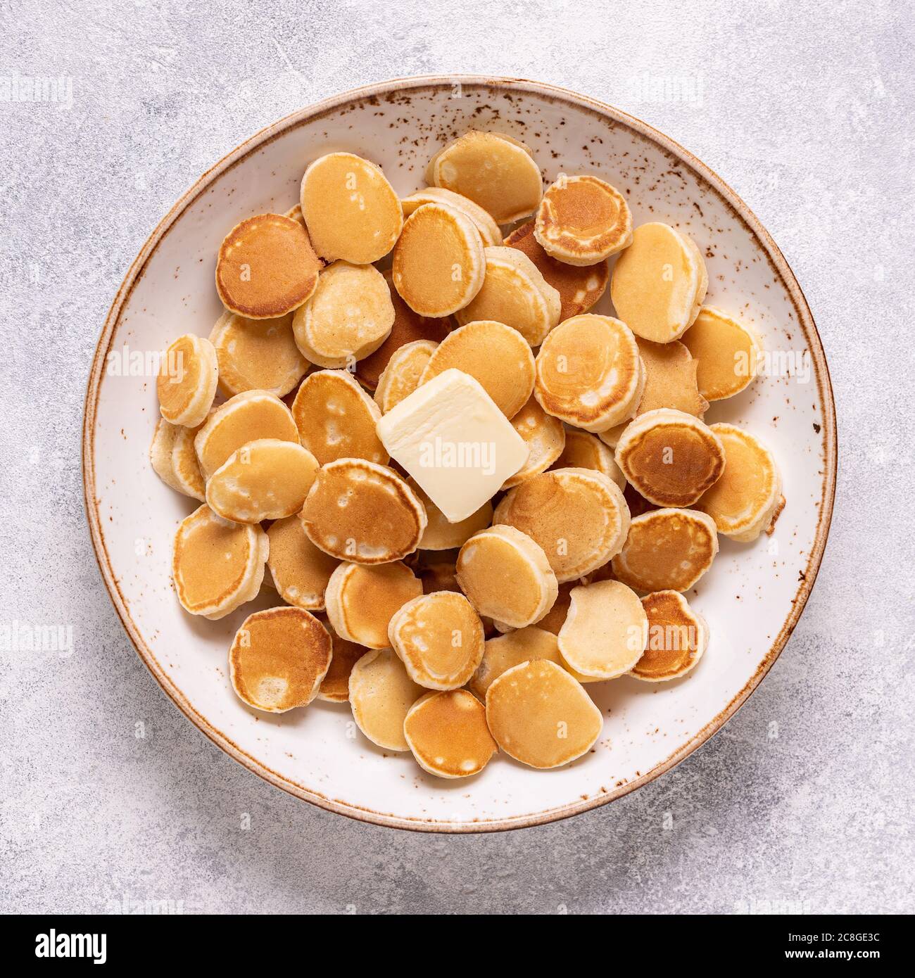 Colazione alla moda con mini pancake e burro, vista dall'alto. Foto Stock