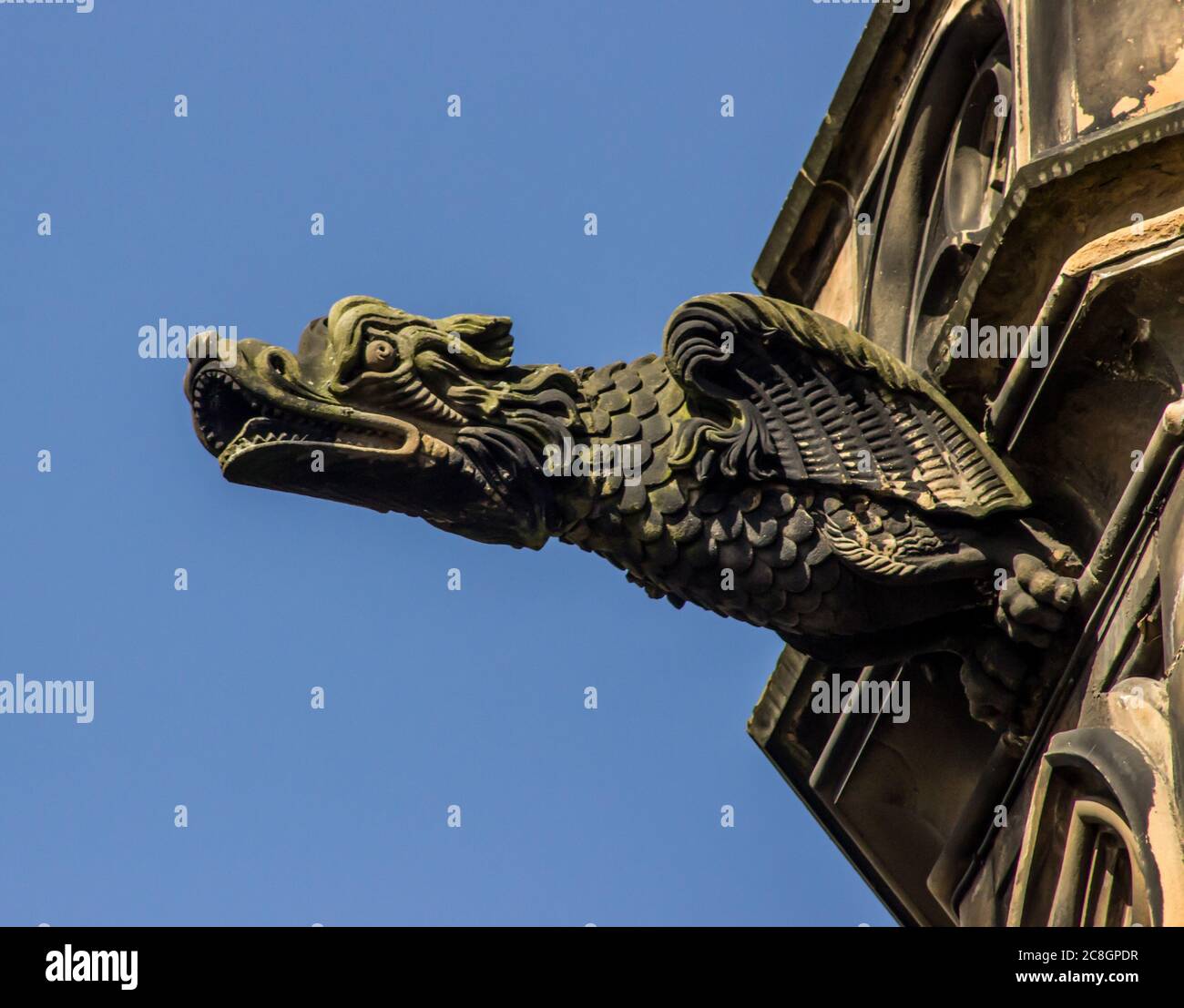Un Gargoyle a forma di Drago sul Monumento scozzese, in una giornata di sole e limpida, fotografato nei Princess Gardens, Edimburgo, Scozia Foto Stock