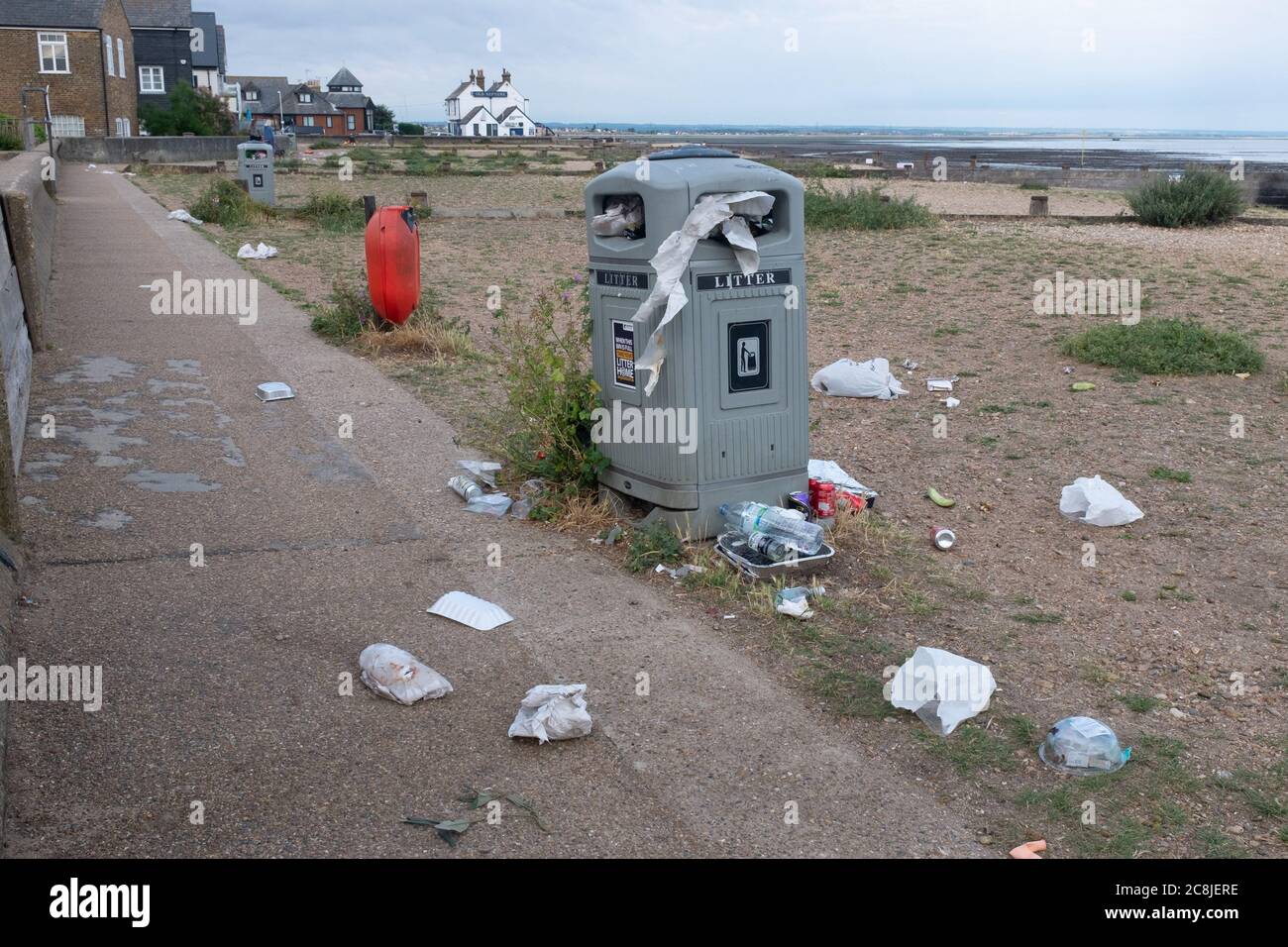 La mattina dopo sabato sera, folle di feste sulla spiaggia dei giovani, la loro cucciolata e spazzatura dalla notte prima, è disseminata attraverso i sentieri costieri e si inchita lungo le mura del mare, il 19 luglio 2020, a Whitstable, Kent, Inghilterra. Un gruppo di volontari locali e di pulizia del consiglio arriveranno presto per la pulizia mattutina regolare che è peggiorata, dicono, durante il blocco pandemico di Coronavirus e ora, il lento allentamento delle linee guida sanitarie. Foto Stock