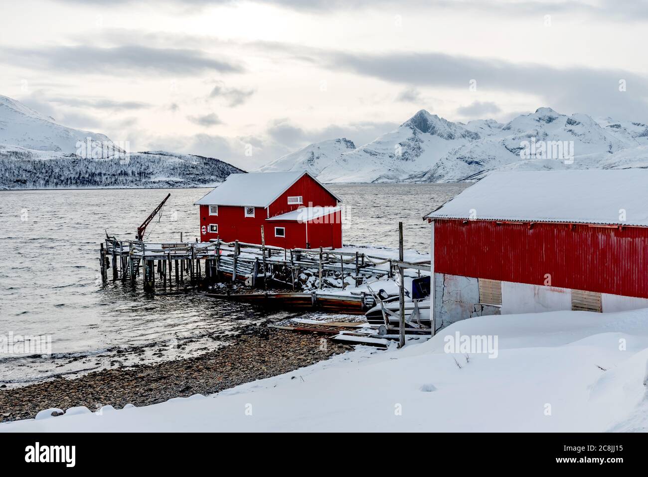 NORVEGIA, KVALOYA - 14 MARZO 2020 - inverno scenario atmosferico con molo di pesca nel fiordo Skulsfjord vicino Tromso Foto Stock