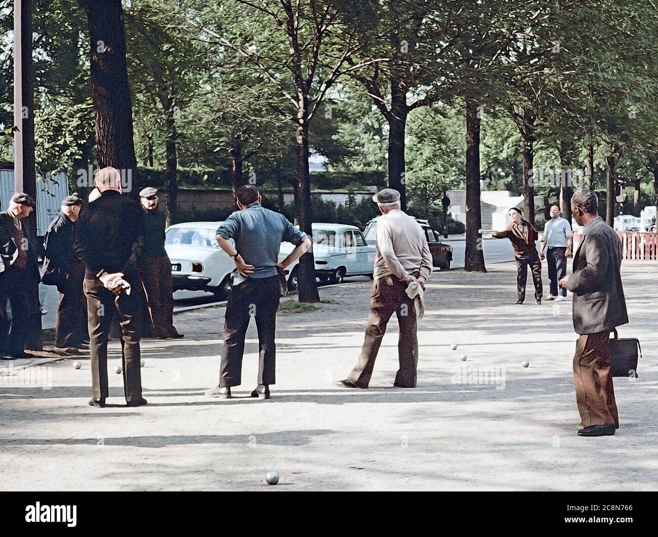 Illustrazione della foto - gli uomini si riuniscono per un gioco precoce og boules, il modo perfetto per iniziare la loro giornata, e un commuter guarda sopra Foto Stock