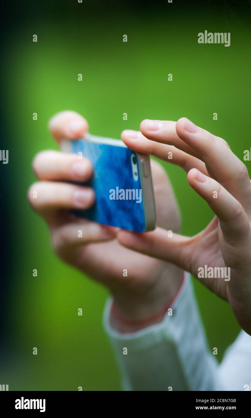 Scatto: Mani che tengono lo smartphone e scattano foto Foto Stock
