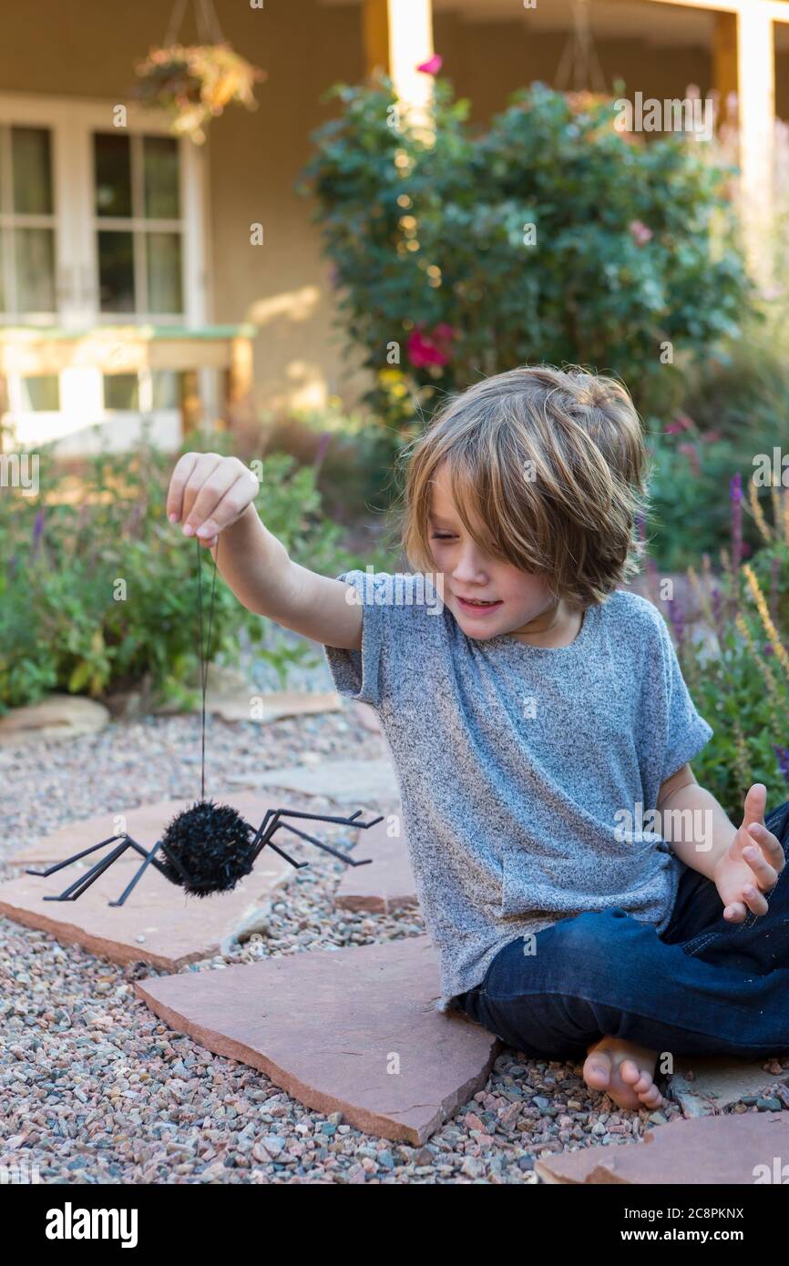 ragazzo di 4 anni che gioca nel cortile di casa Foto Stock