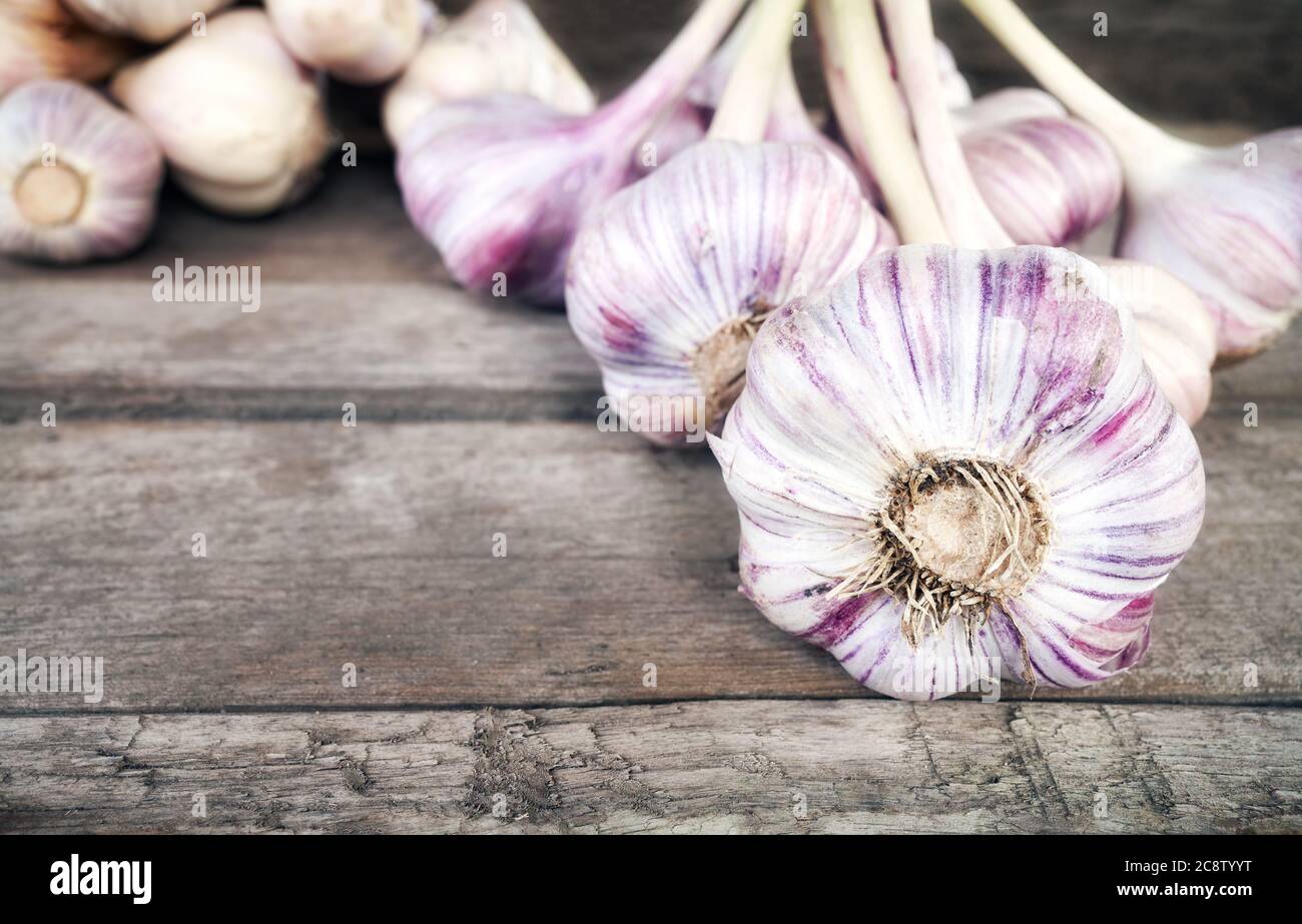 Primo piano immagine di aglio organico fresco su un tavolo di legno, fuoco selettivo. Foto Stock