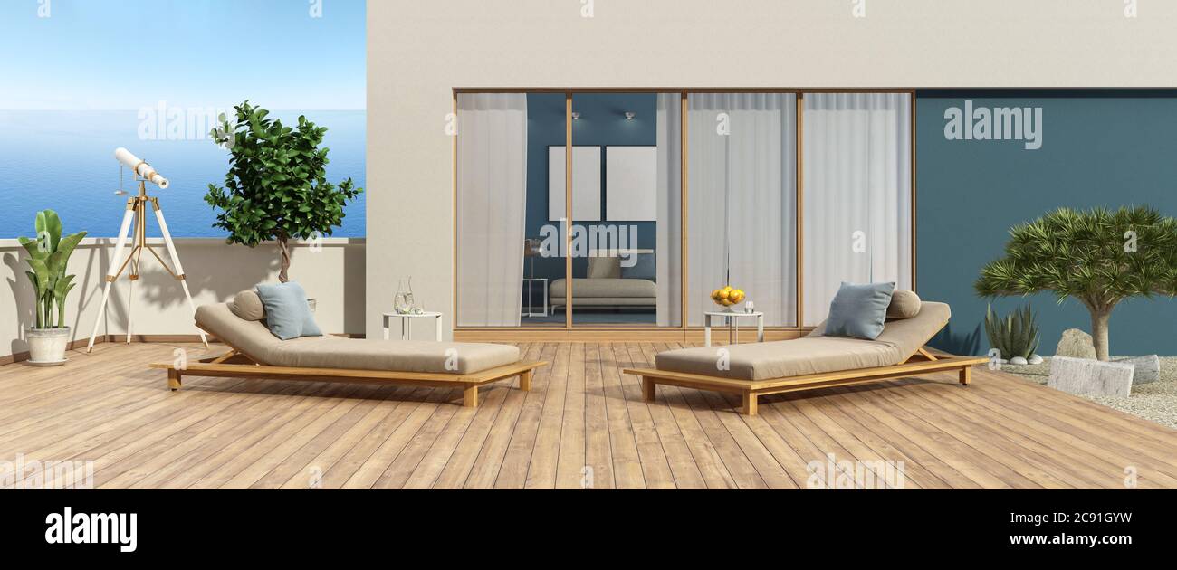 Terrazza di una villa moderna che si affaccia sul mare e due chaise lounges sul pavimento in legno - rendering 3d Foto Stock