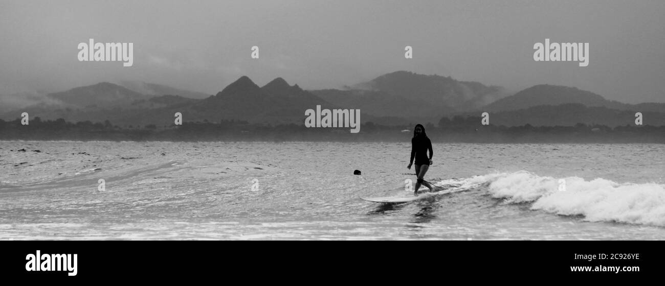 BYRON BAY, AUSTRALIA - 24 agosto 2016: Vecchia scuola Surf ragazza a Byron Bay in bianco e nero Foto Stock