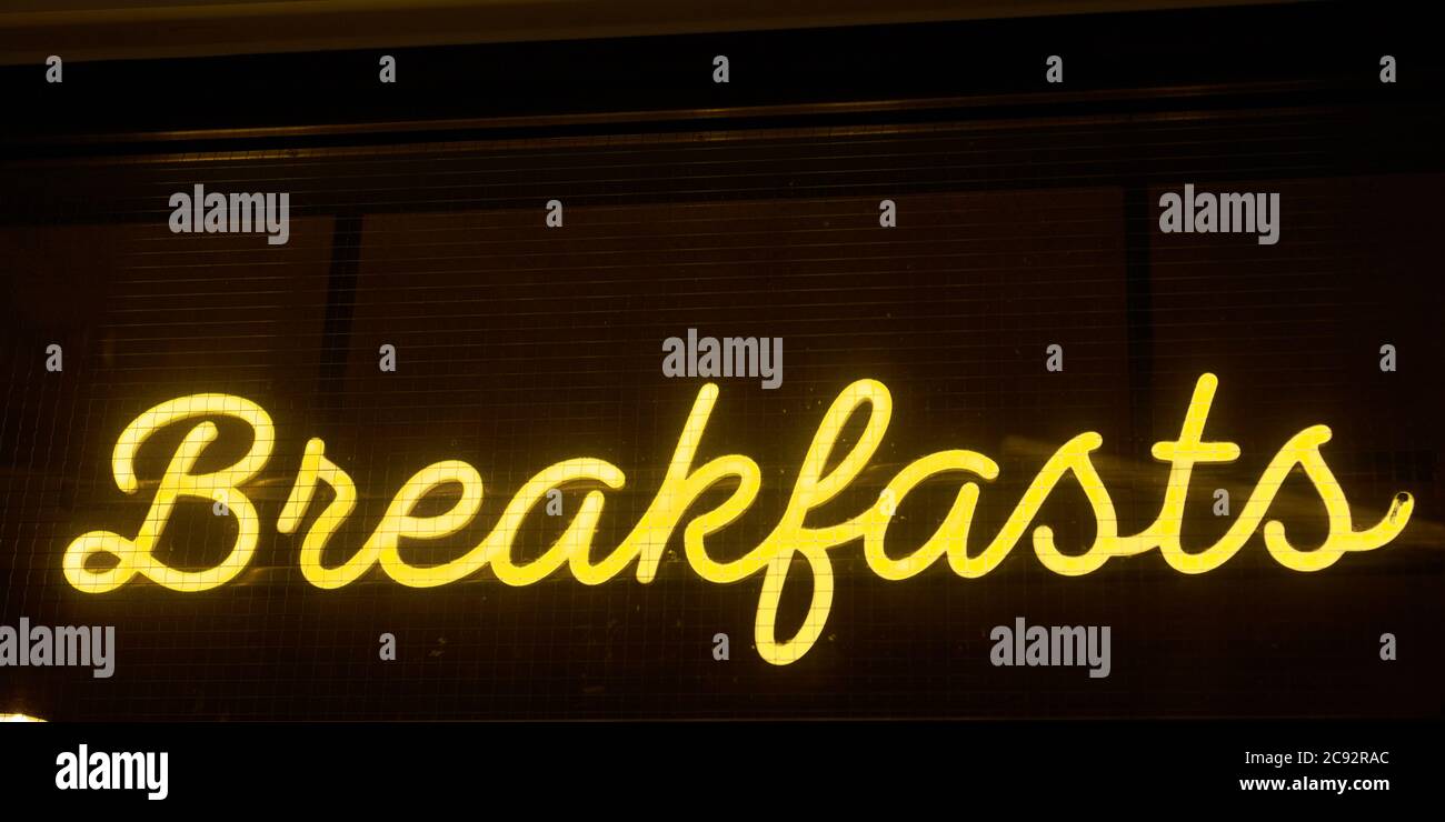 Al neon, all'esterno di un ristorante nel terminal dell'aeroporto di Luton, c'è un cartello con su scritto Reading Breakfast. Foto Stock