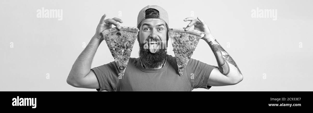 Ritratto di un bell'uomo che mangia una fetta di pizza margherita. Foto Stock