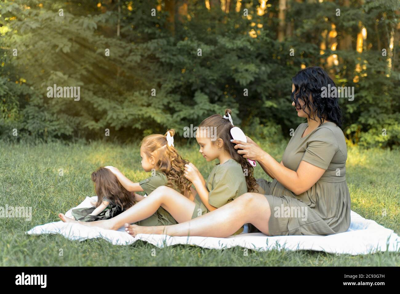 ragazza incinta con due bambini in natura. Madre sta aspettando una ragazza Foto Stock