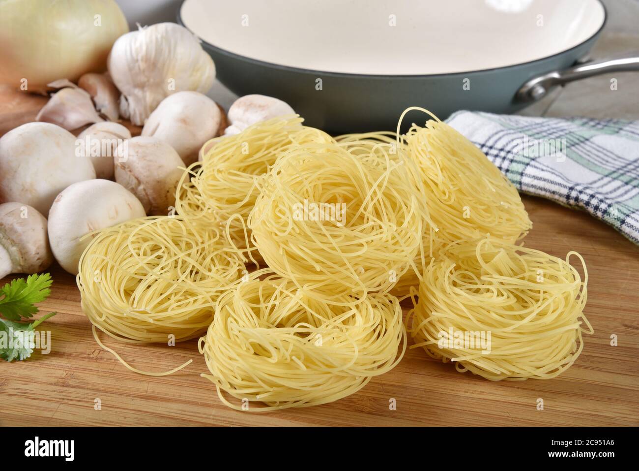 La pasta per capelli d'angelo nidifica con funghi, cipolle e altri spaghetti ingredienti Foto Stock