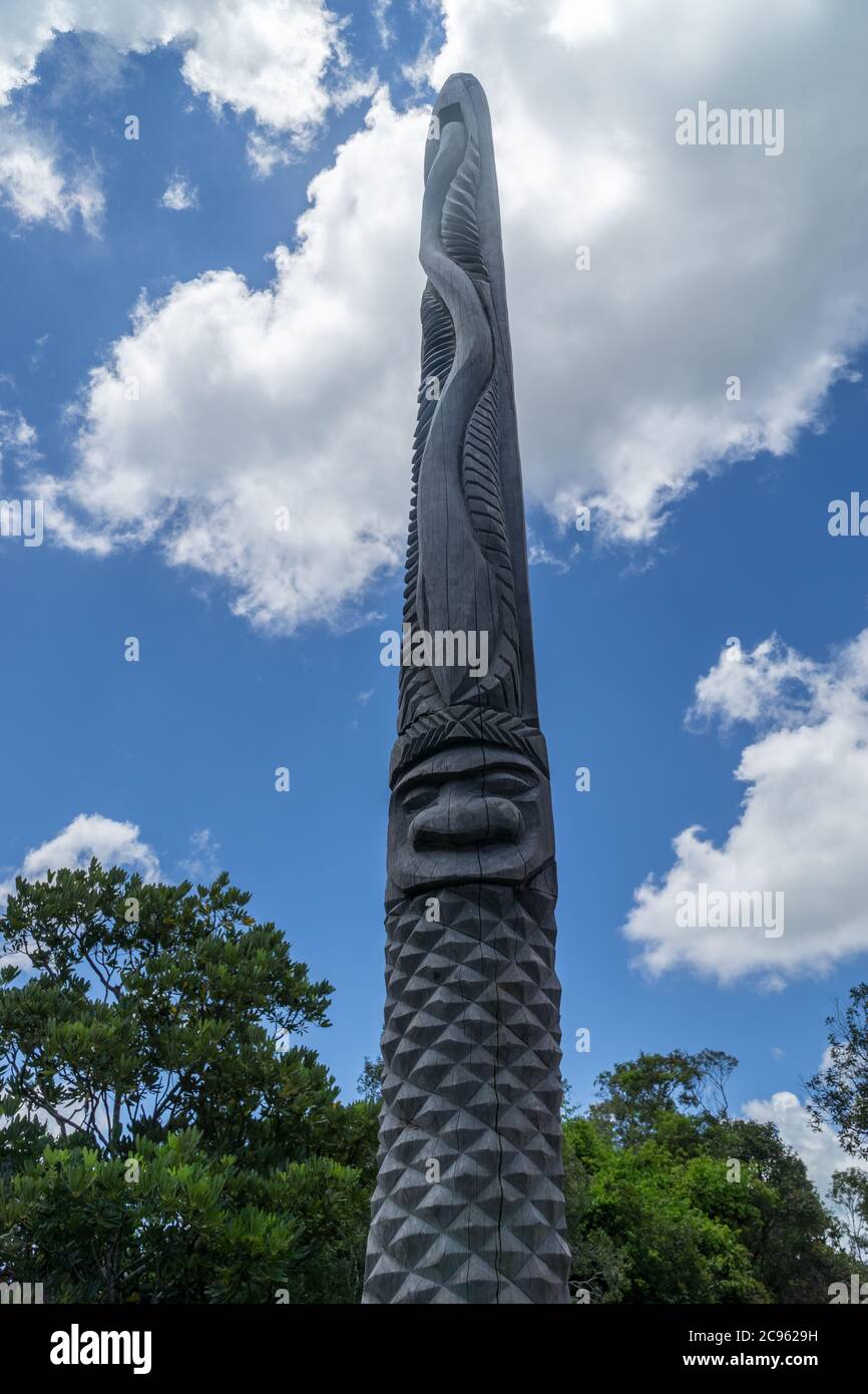 Enorme totem in legno tipico caledoniano nuovo. Parc des Grandes Fougères, Nuova Caledonia. Il cielo è blu Foto Stock