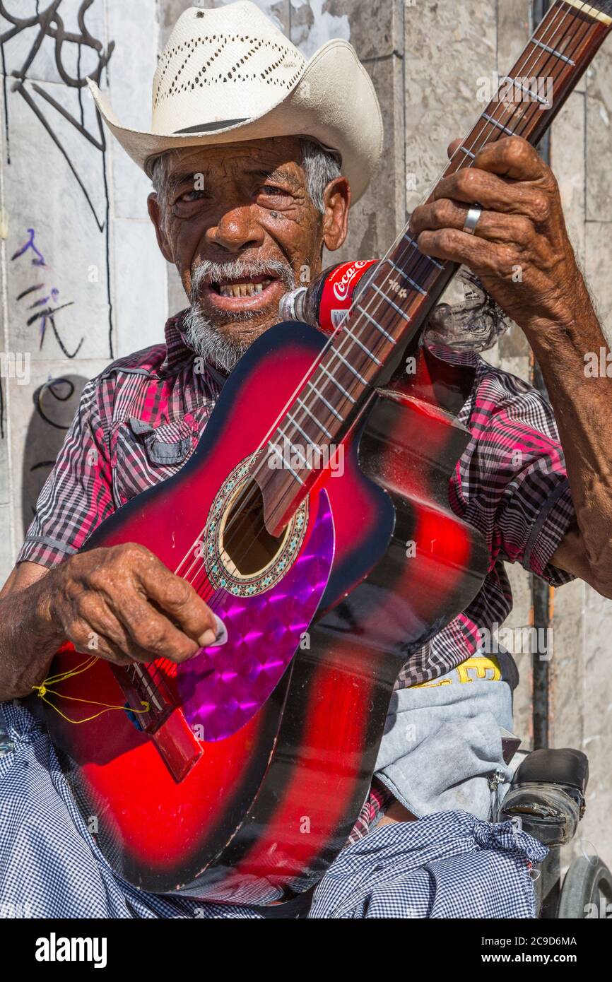 Ciudad Juarez, Chihuahua, Messico. Musicista di strada che gioca la sua chitarra e canto. Foto Stock