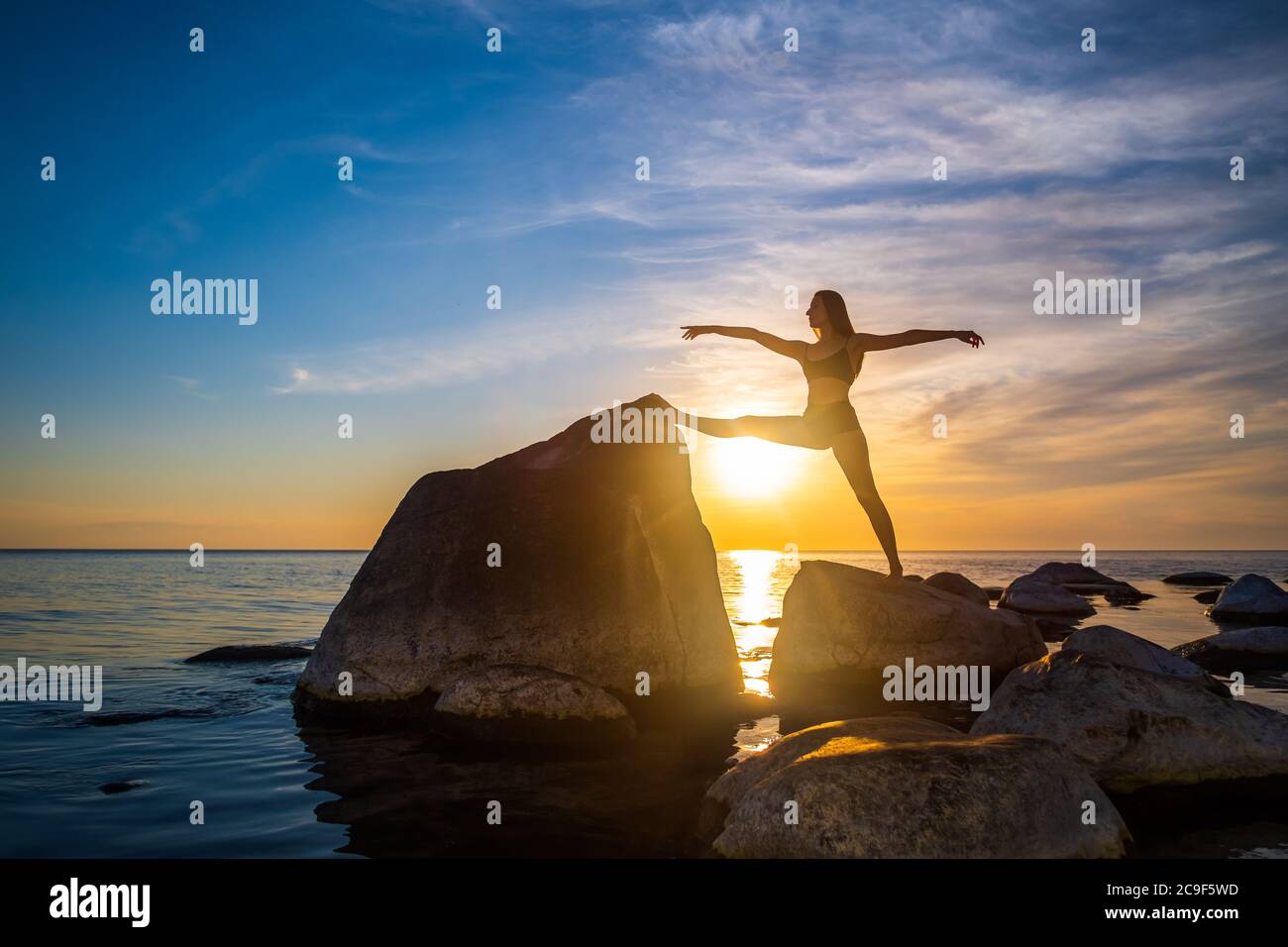 Slim femminile che si allunga al tramonto Foto Stock