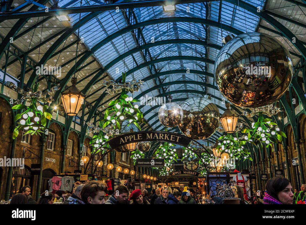 Covent Garden, London Apple Market decorato per Natale con gli acquirenti in primo piano Foto Stock